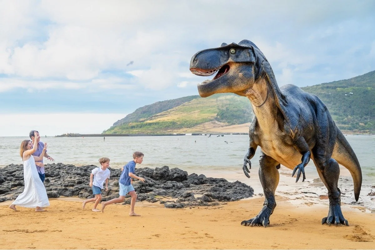 Family running from a dinosaur during their Kauai Photo Session