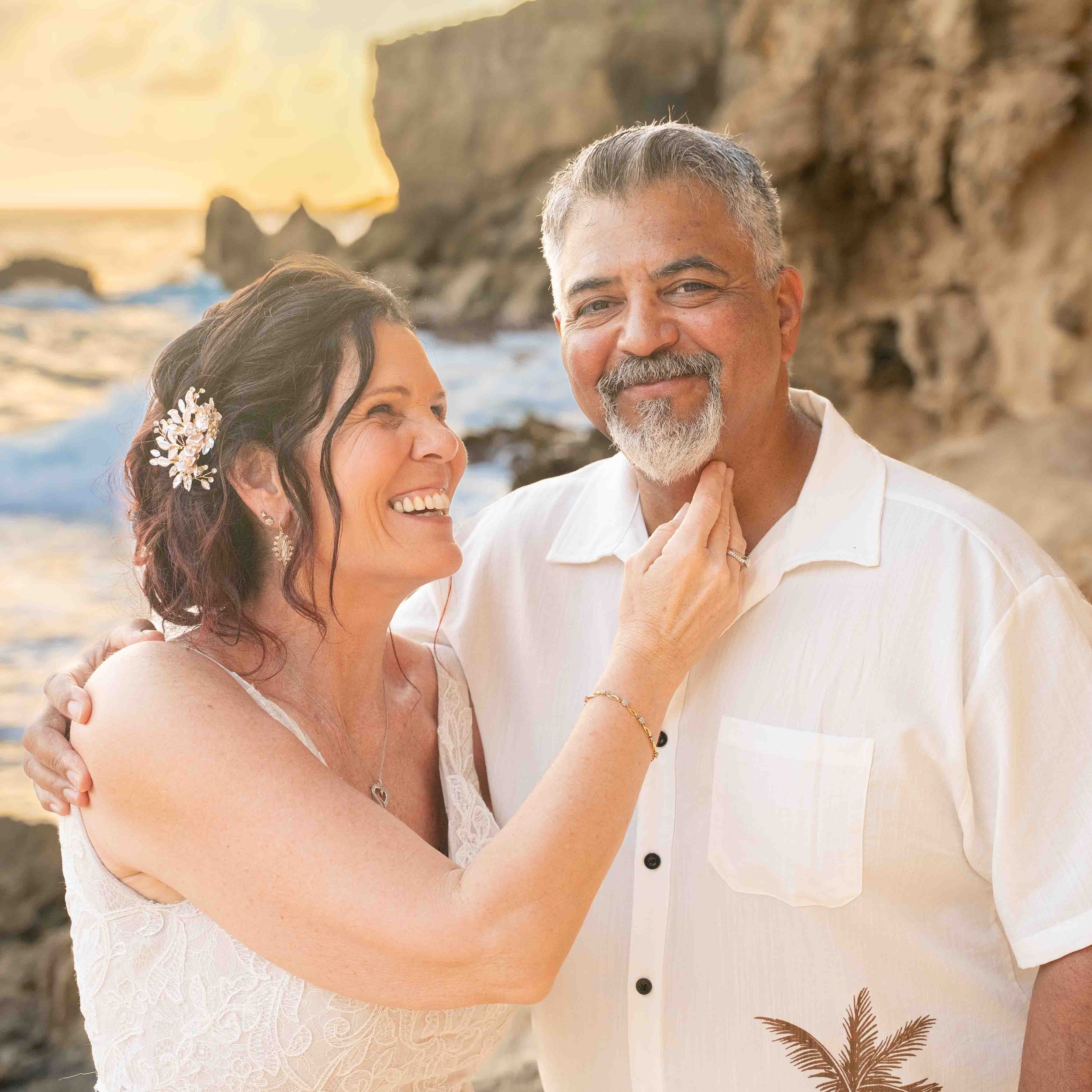Close-up of a laughing older couple at Shipwreck Beach, Kauai.