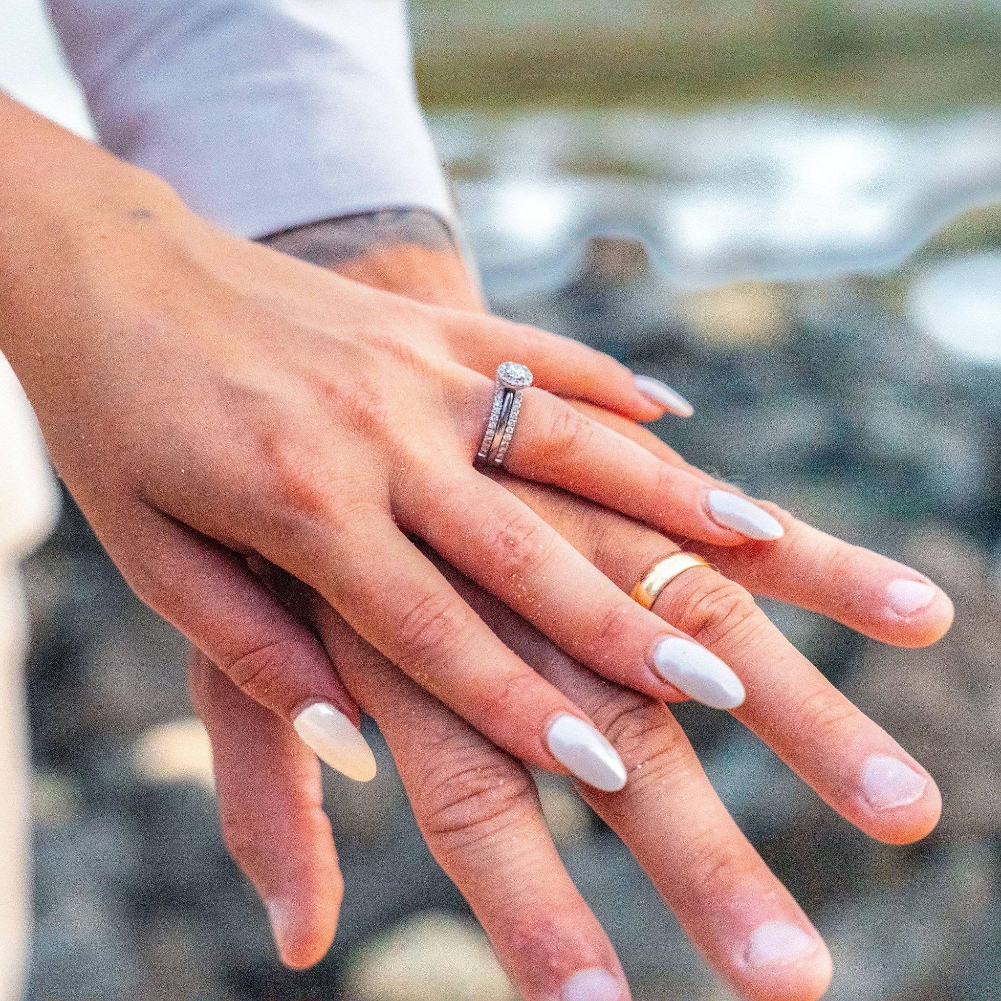 Close-up of a couple's hands showing their wedding rings in Kauai.