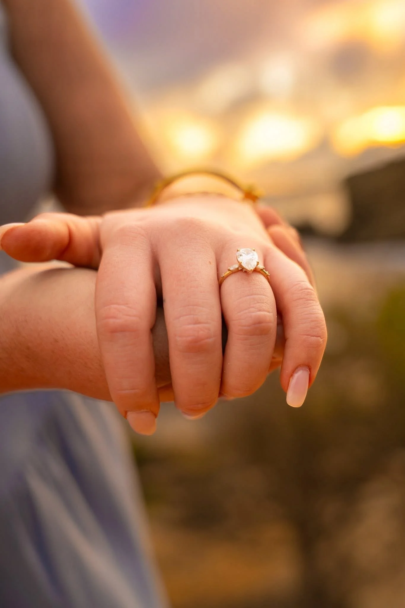 Close-up of an engagement ring on a woman's hand in Kauai.