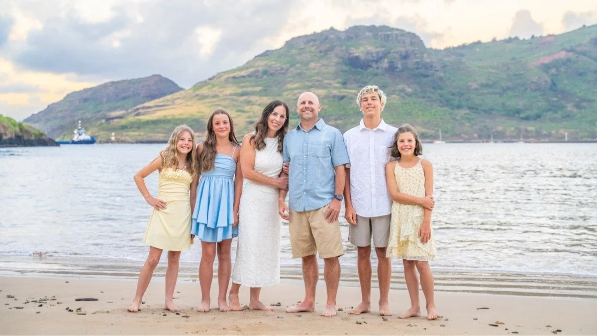 Cruise passenger family photos at Nawiliwili, Kauai, with the ship behind them