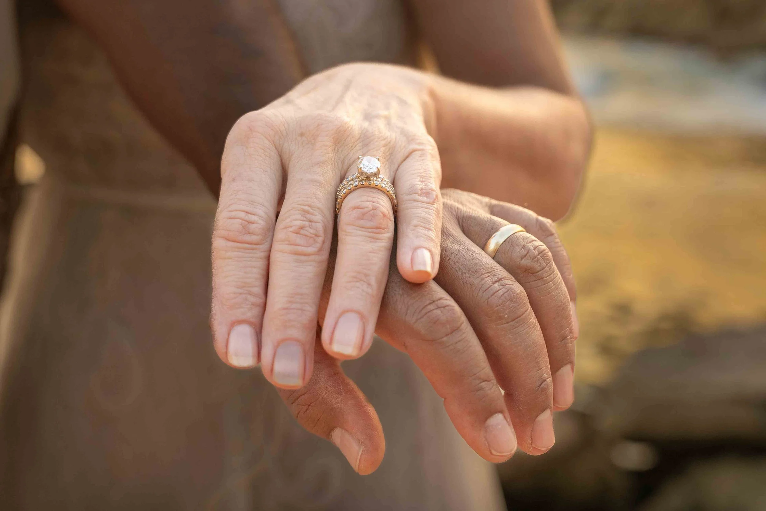 Close-up of a couple's hands showing wedding bands in Kauai.