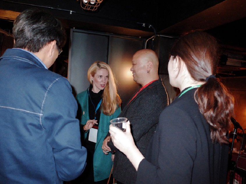 Here is a close-up of two men and two women engaged in conversation.