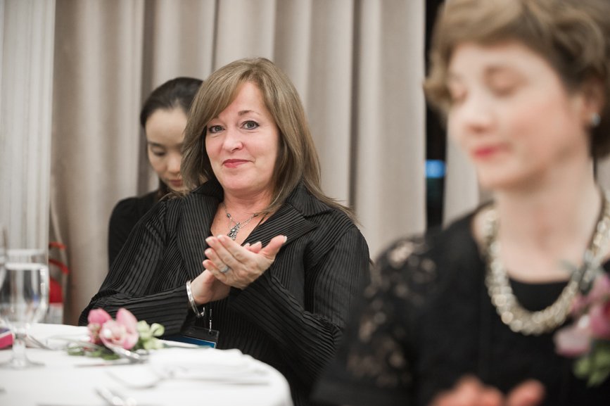 Ms. Rhodes and Jane Nuzzo, the Director of Alumni Affairs, are seen participating in the alumni association gathering.