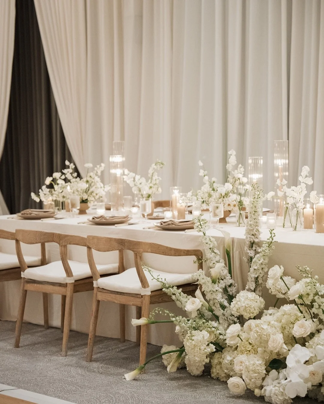 Soft textures and tonal whites. This wedding layered florals, candlelight, and draped details to create an atmosphere that feels both intimate and refined. 

Bride and Groom: @jamie_comstock and @elarson34
Planning and Design: @westgate.events
Lead P