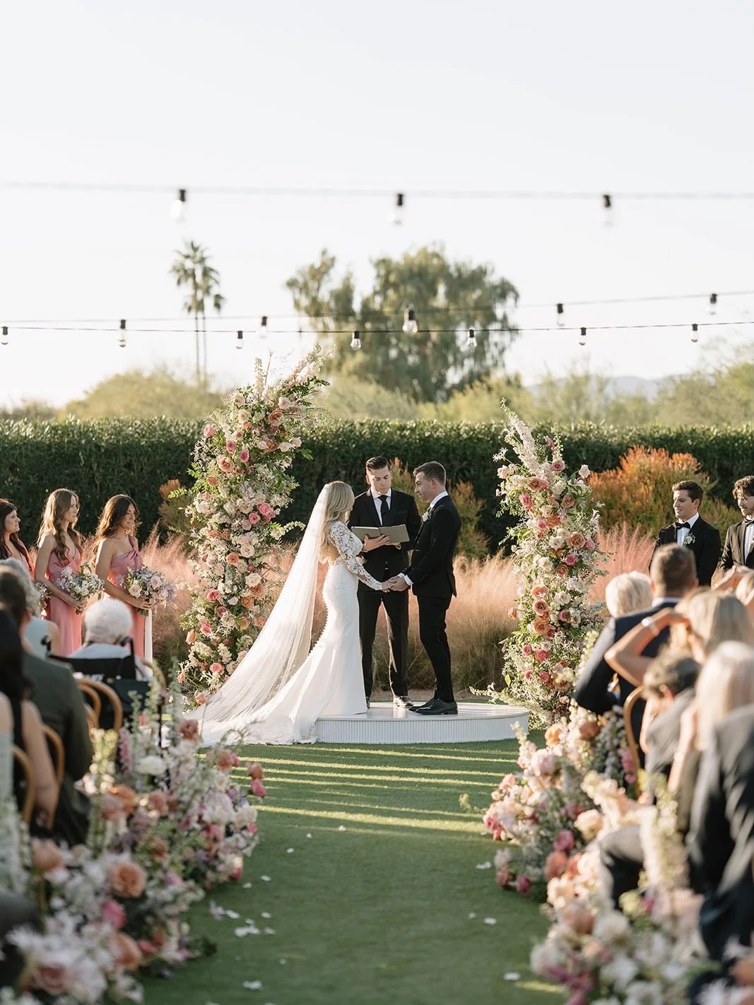 Romantic wedding ceremony at @andazscottsdale with lush aisle arrangements + statement floral pillars! 

Planning and design: @dasheventcompany
Venue: @andazscottsdaleweddings
Photo: @abbyhiggsphotography
Florals: @floralsbykendra 
Tables/Chairs: @le