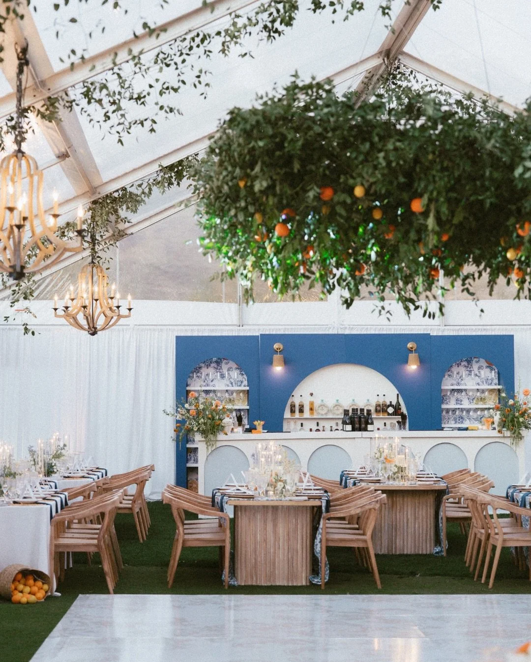 A ceremony framed with abundant greenery and meadow-inspired florals before stepping into a reception layered with soft blue and vibrant orange accents, fresh citrus details, and a floral-covered fountain that stole the show. 

Planner: @audreywoodev