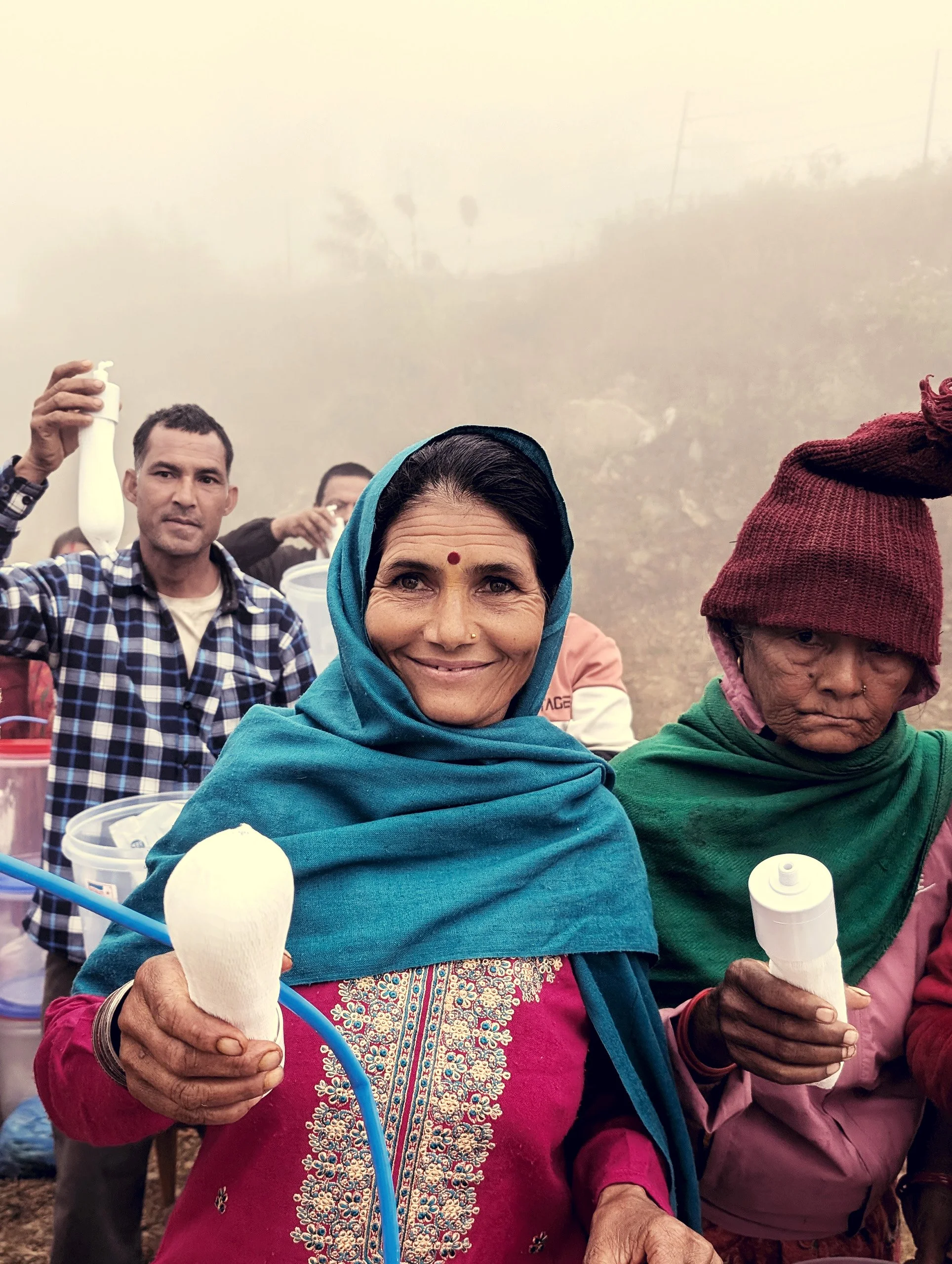 MightyWater_Nepal2024_WomanWithFilter_RobMiller.jpg