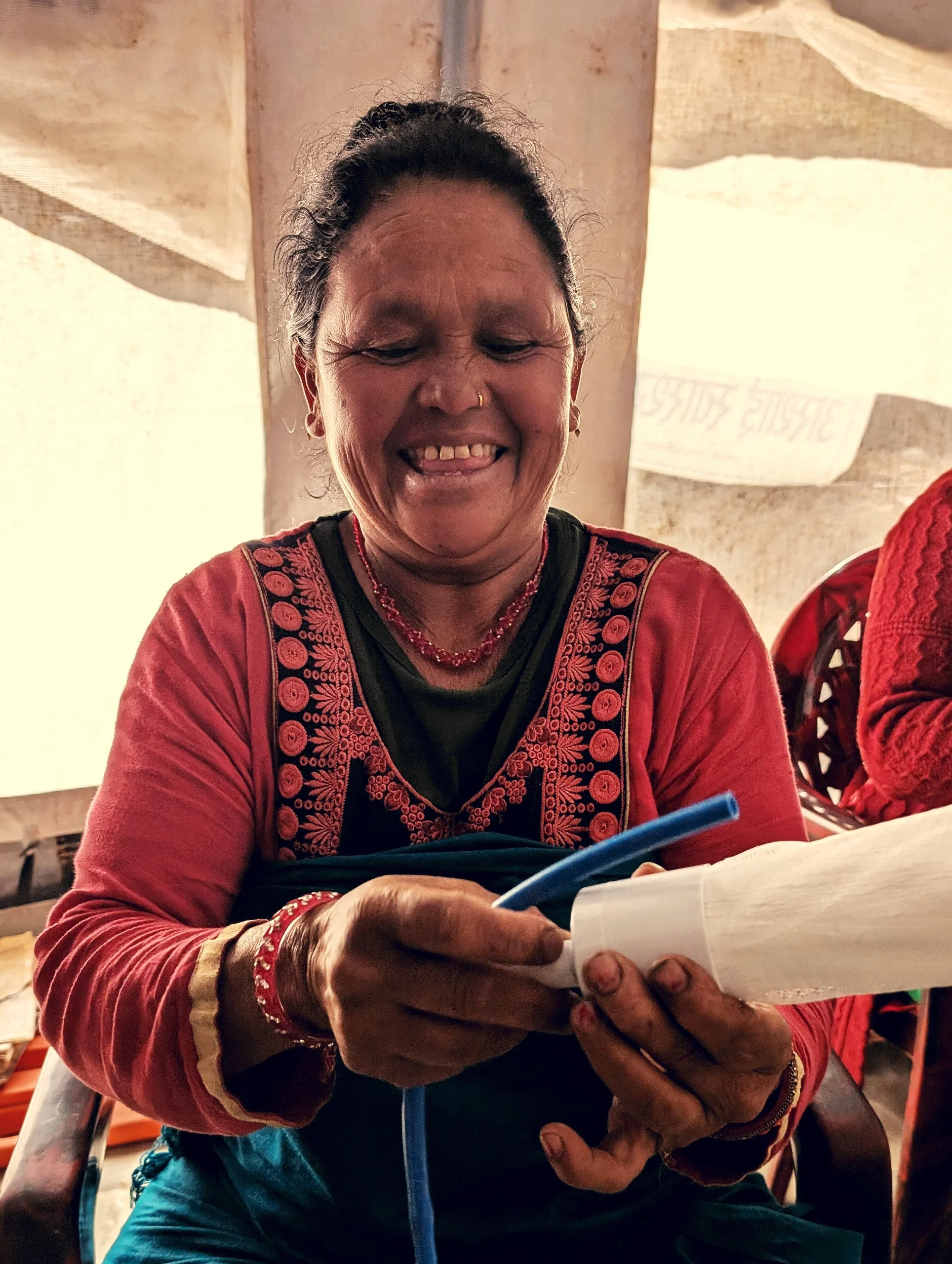 MightyWater_Nepal2024_WomanBuildingFilterSystem_RobMiller.jpg