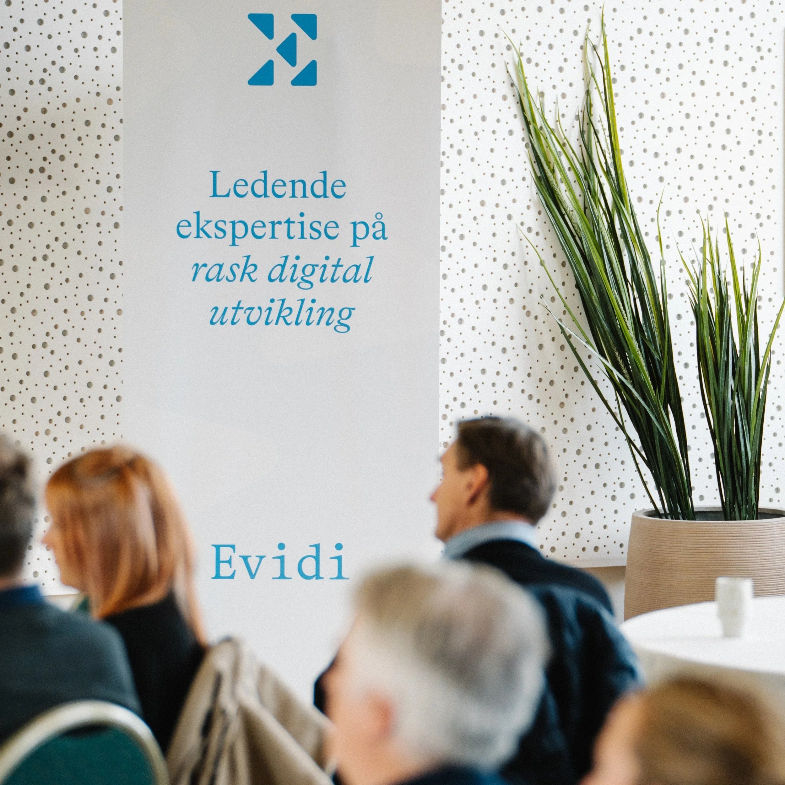 A person holding a yellow marker and drawing on a detailed construction or engineering blueprint laid out on a large white table.
