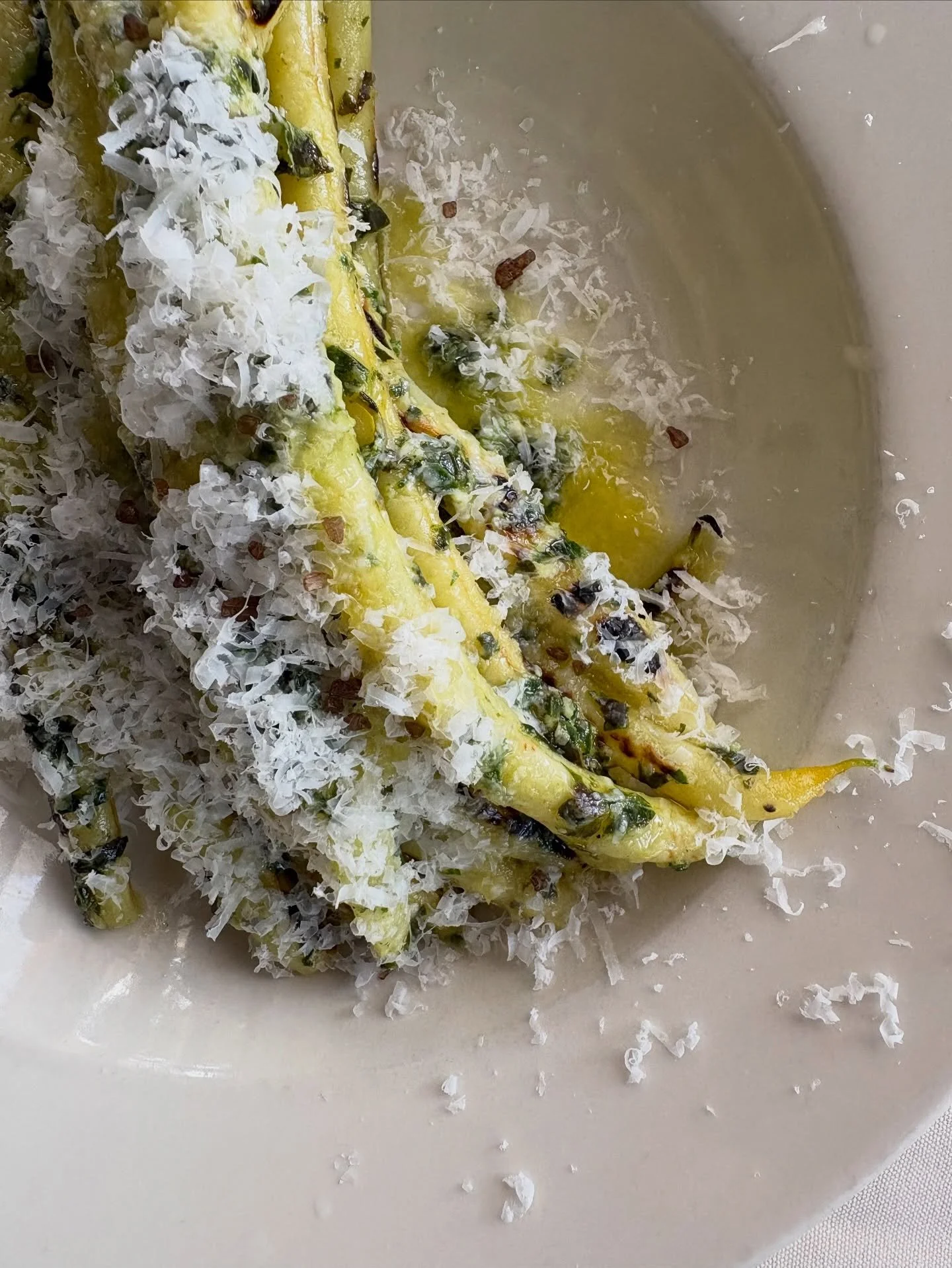 Yellow wax beans that have been charred and dressed simply in pesto. Parm on top 🫛