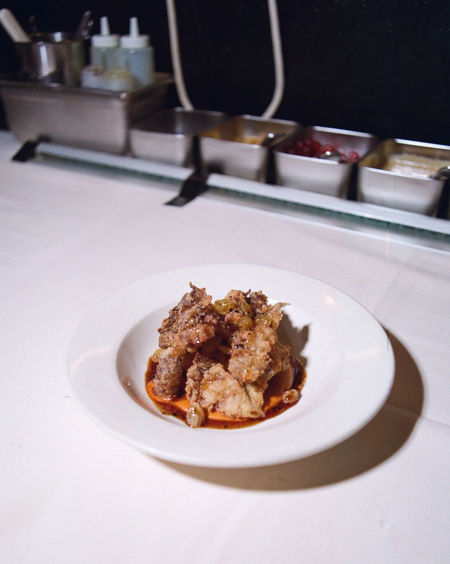 Fried sunchokes drizzled in an Aleppo chili glaze with a burnt red pepper sauce and pickled raisins. It&rsquo;s Monday, we&rsquo;re open and all cozy and warm and safe from the rain ☔️ 

📸: @robbklassen