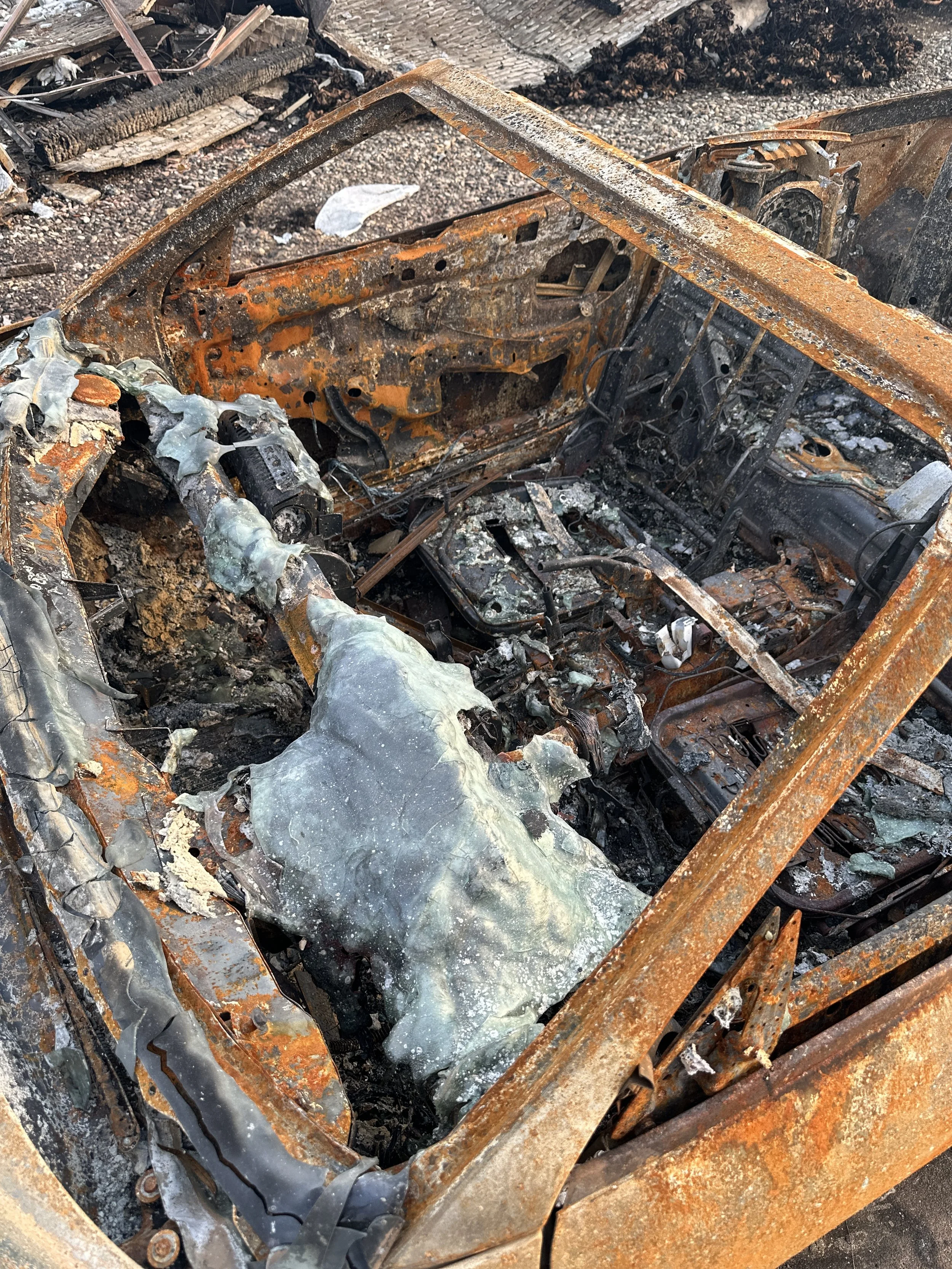 A glass front window of a car melted into frozen puddles by the intensity of heat during the
Palisades Fire.   Photo credit: Adriana Cargill
