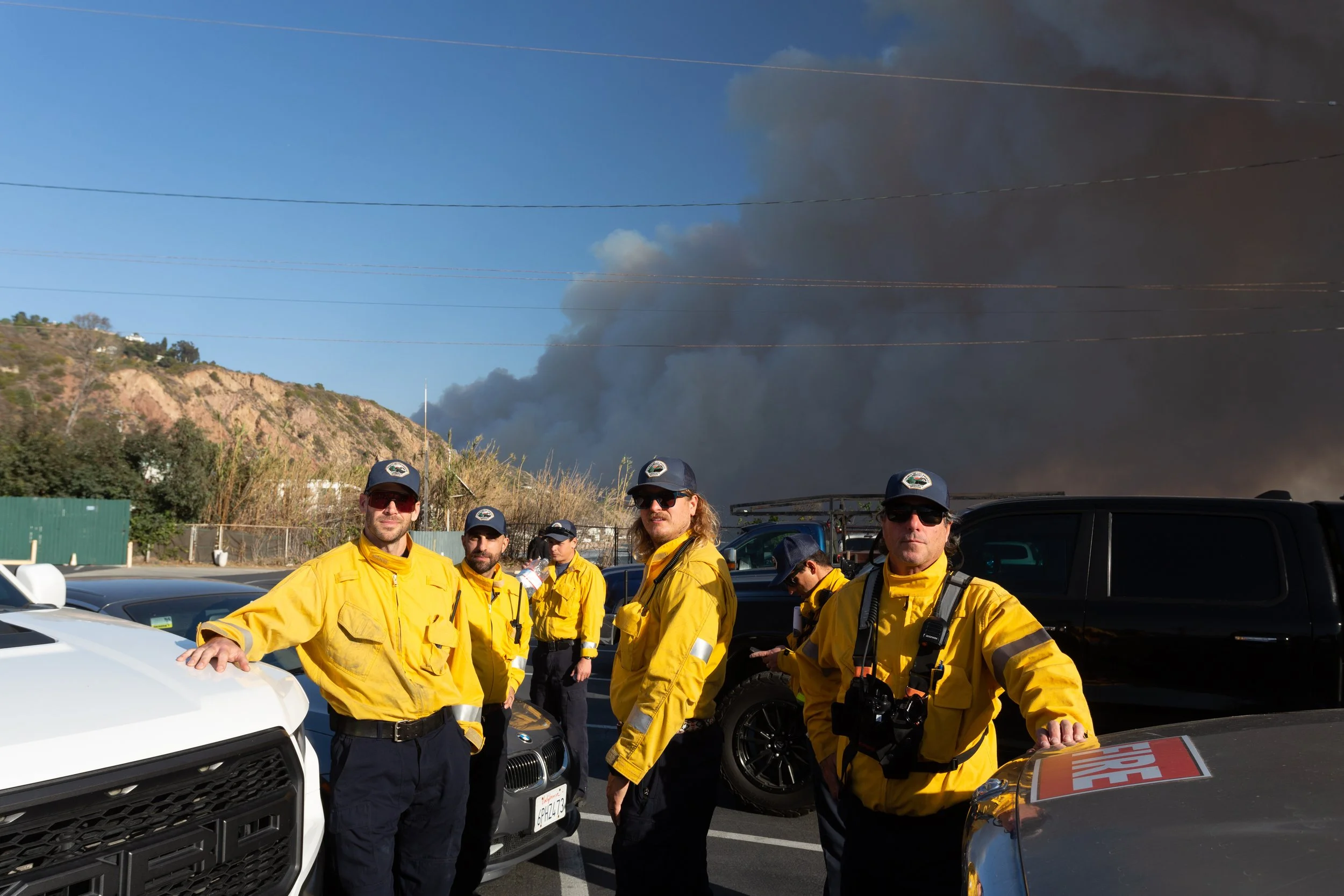 Community brigade members on the PCH in Dukes Parking lot at 1:40pm on January 7, 2025
mustering to organize, break up into groups and head into different neighborhoods to evacuate residents. The group's number one priority is life safety so they spe