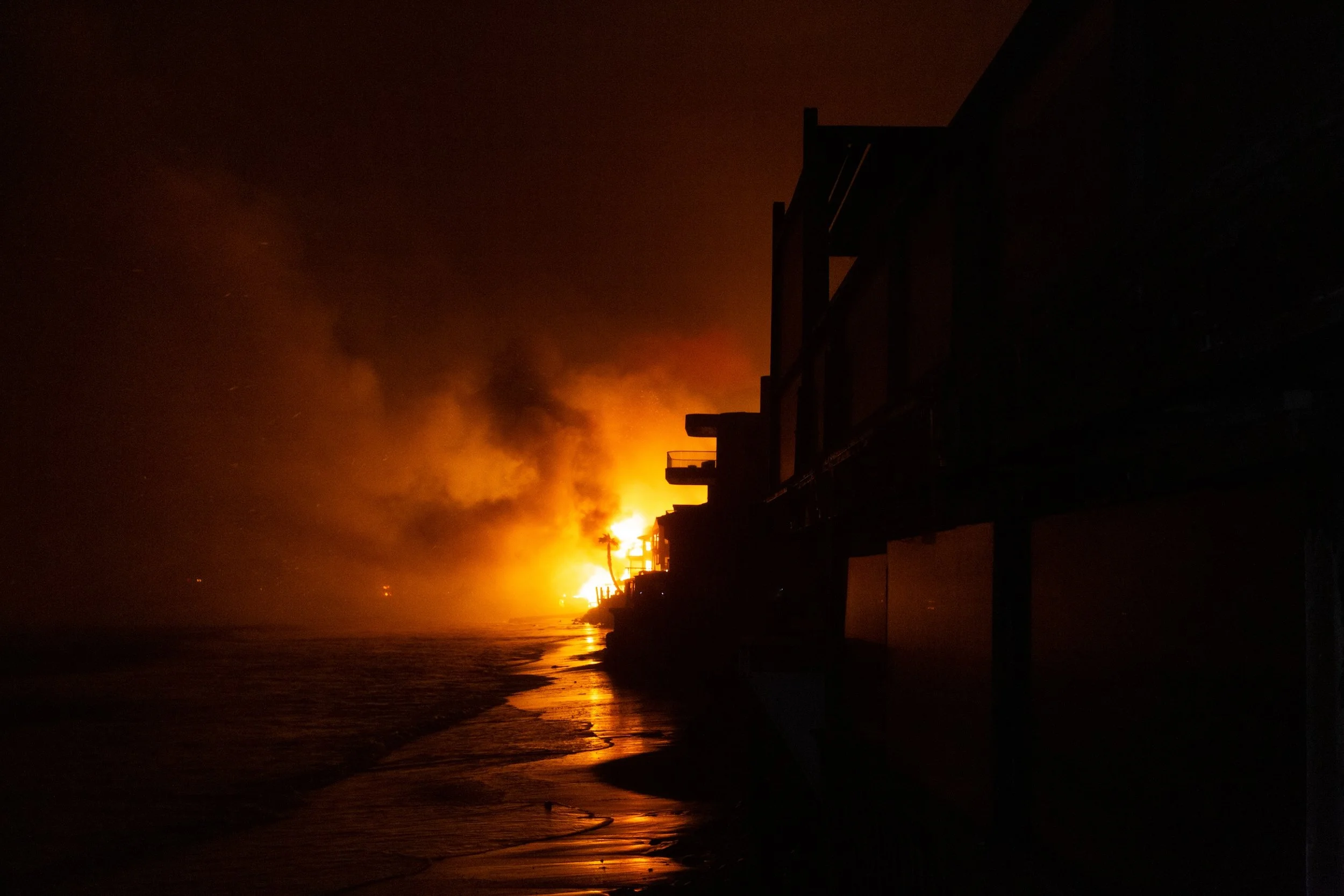 Homes burning along the PCH on Jan 7, 2025. 

 Photo Credit: Clay Bush