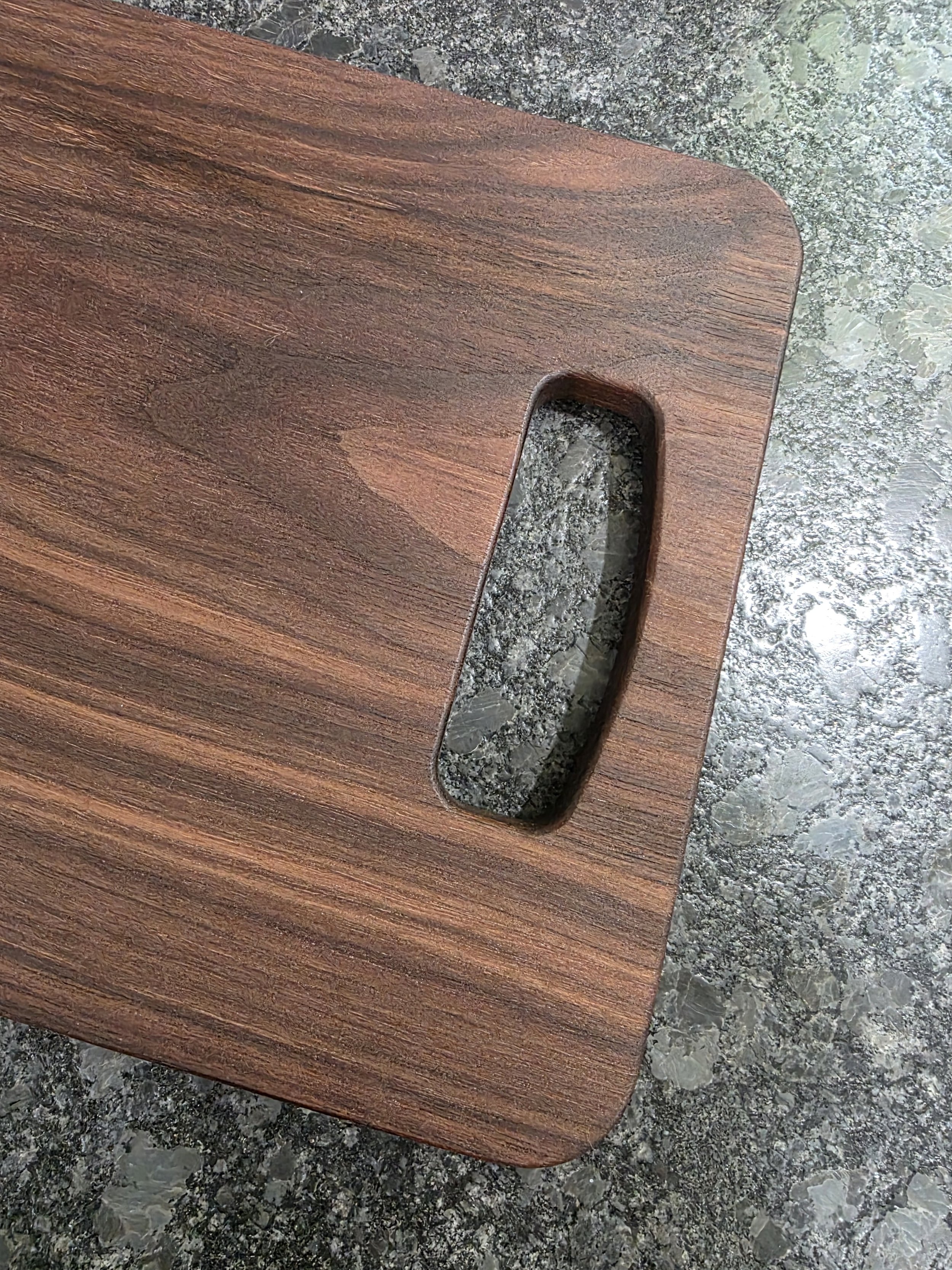 American walnut cutting board with handle.