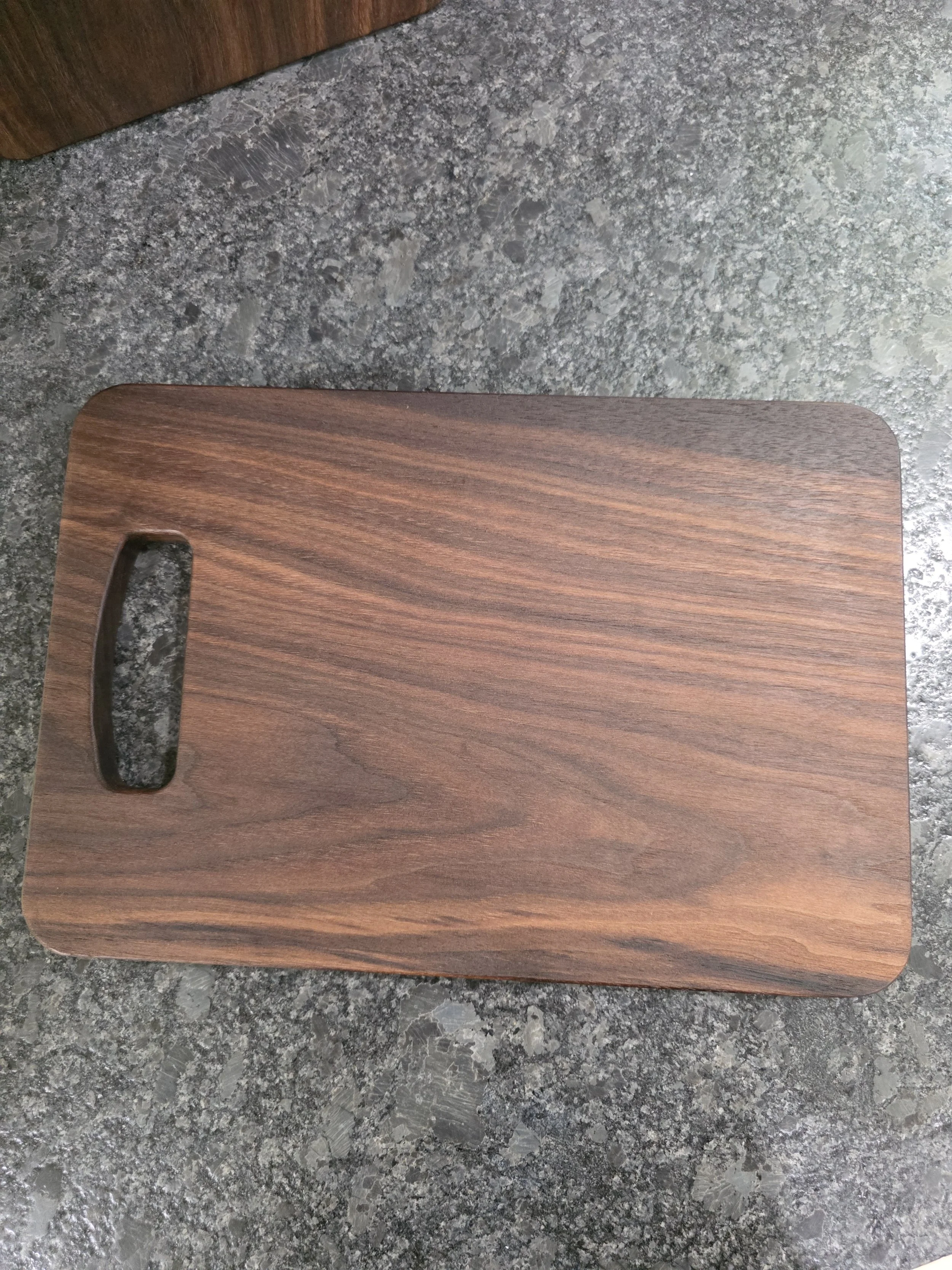 Solid one piece of wood walnut cutting board.