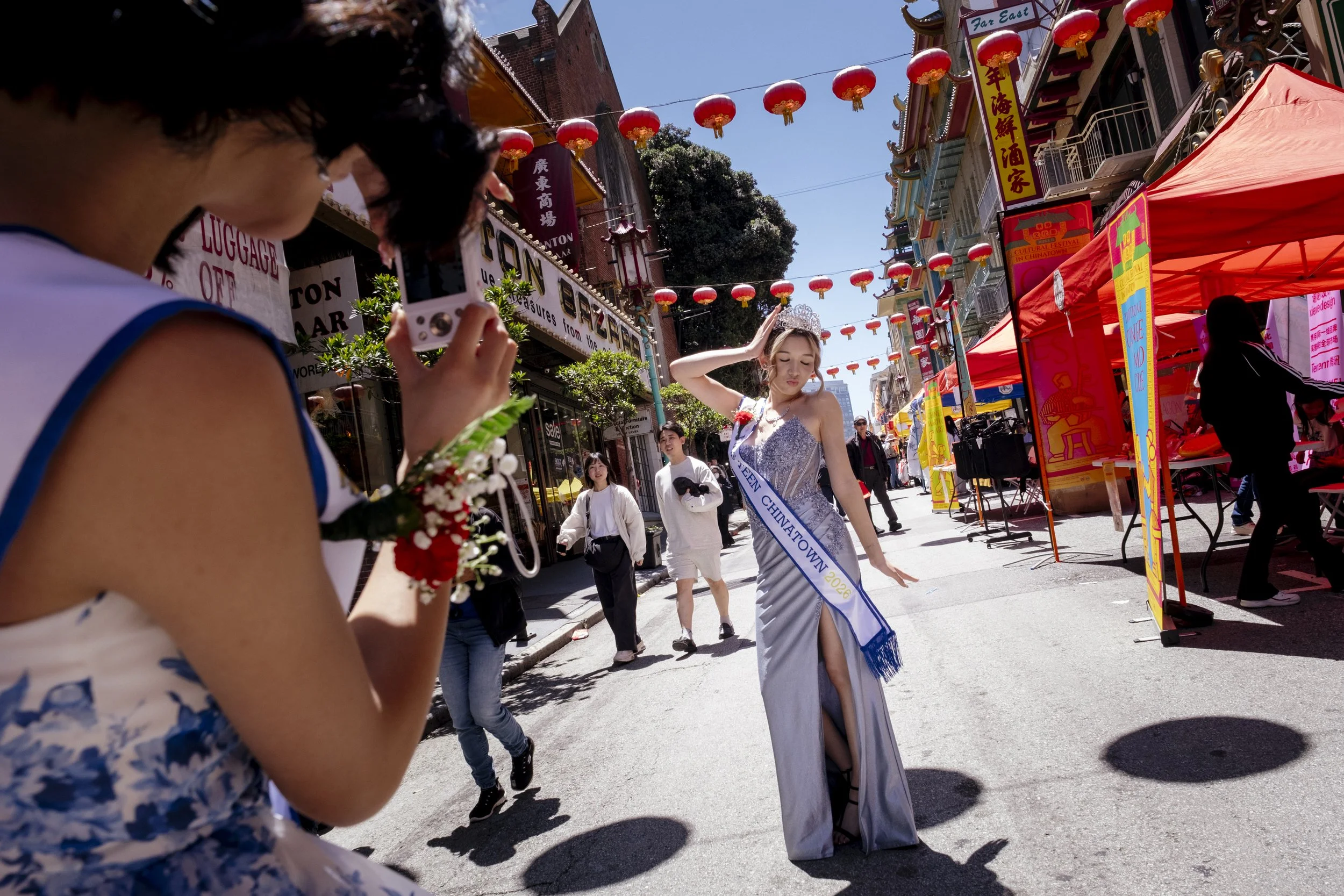 Milo Kirby, 16, gets her picture taken by her friend, Abigal Li, after their teen pageant league represents the third annual Cultural Festival in San Francisco's Chinatown, in California on May 31, 2026.  The festival continues each year to ensure th