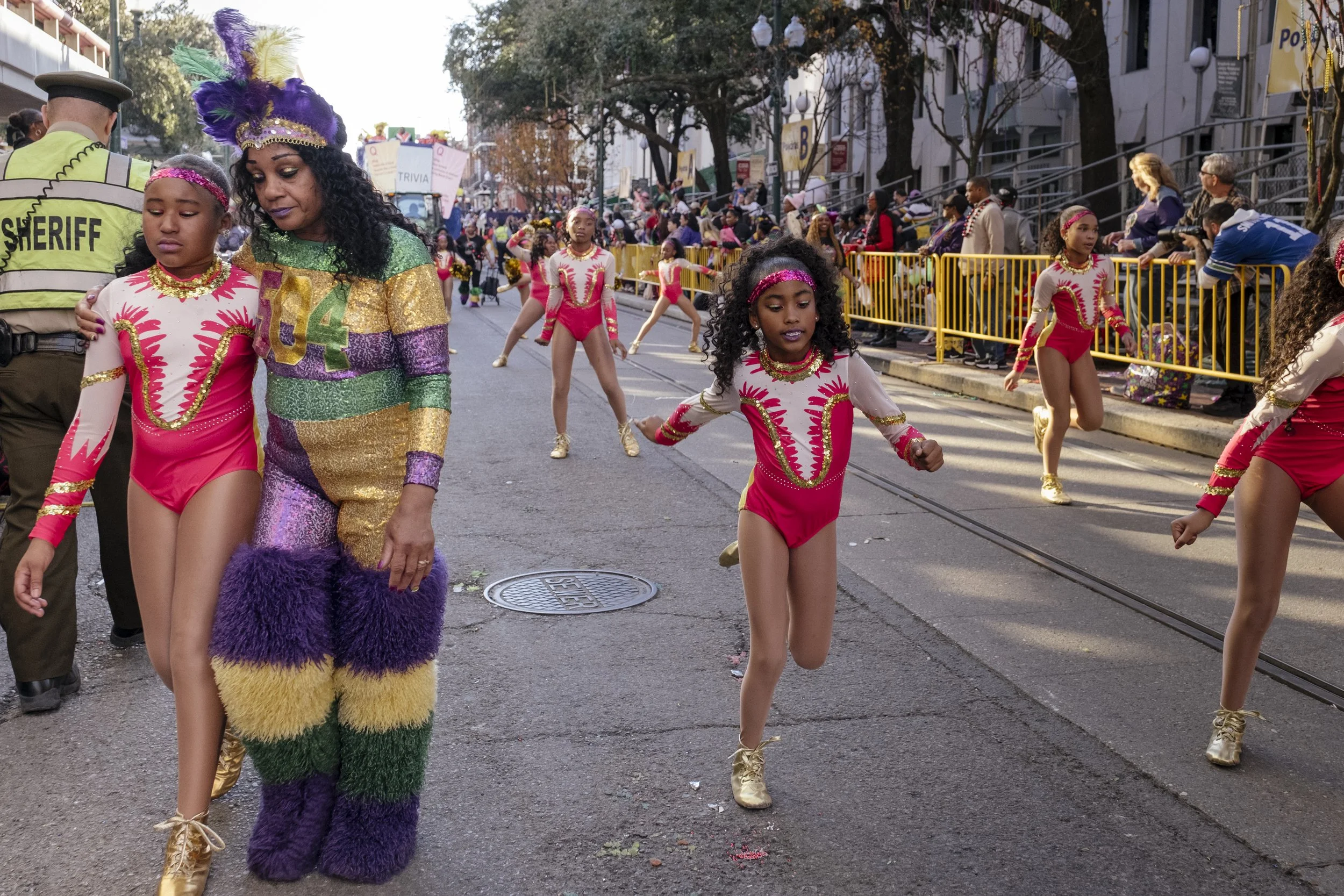 Karen Jordan, 60, comforts a dancer in the heat after they've walked over two miles in the Mardi Gras Mystic Krewe of Femme Fatale parade in New Orleans, Louisiana on February 8, 2026.  "God has given me the opportunity to love what I do, and I love 