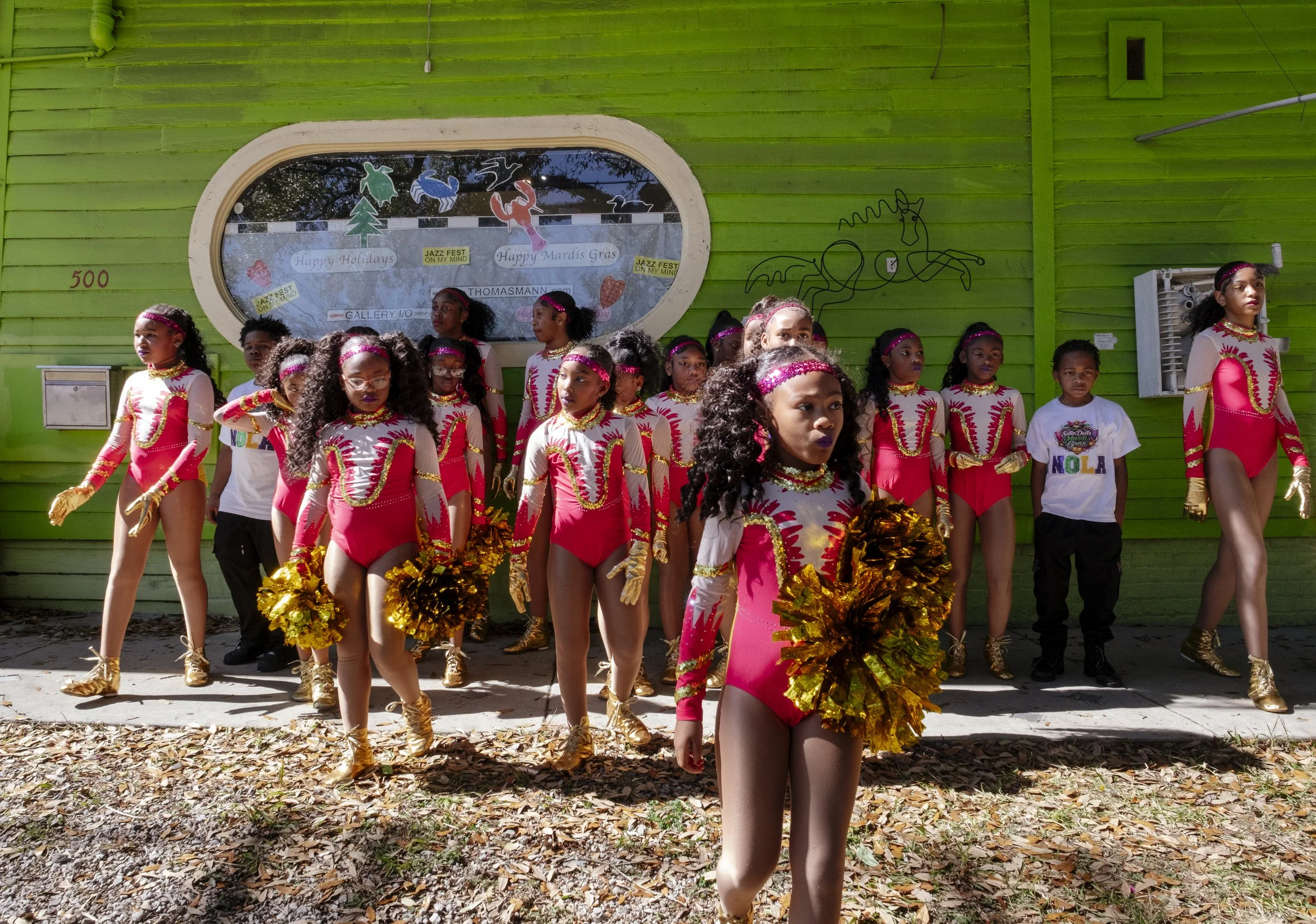 The N.O.E Satin Dolls walk away after getting their portrait taken at Mardi Gras in New Orleans, Louisiana on February 8, 2026.  The dancers wait their turn in line before performing in the Mystic Krewe of Femme Fatale parade in the heat of the day.