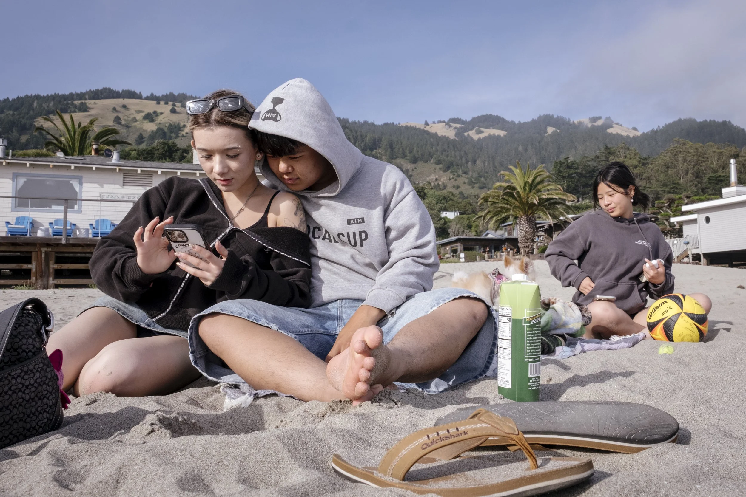 Kirby and her boyfriend, Vincent Yip, 17, look at different raman dinner spots on google maps at Stinson Beach with Kirby's friend Mandy Yu, 15, in Marin County, California on June 2, 2026.  It was Yu's first time being in Marin beacuse of her restri