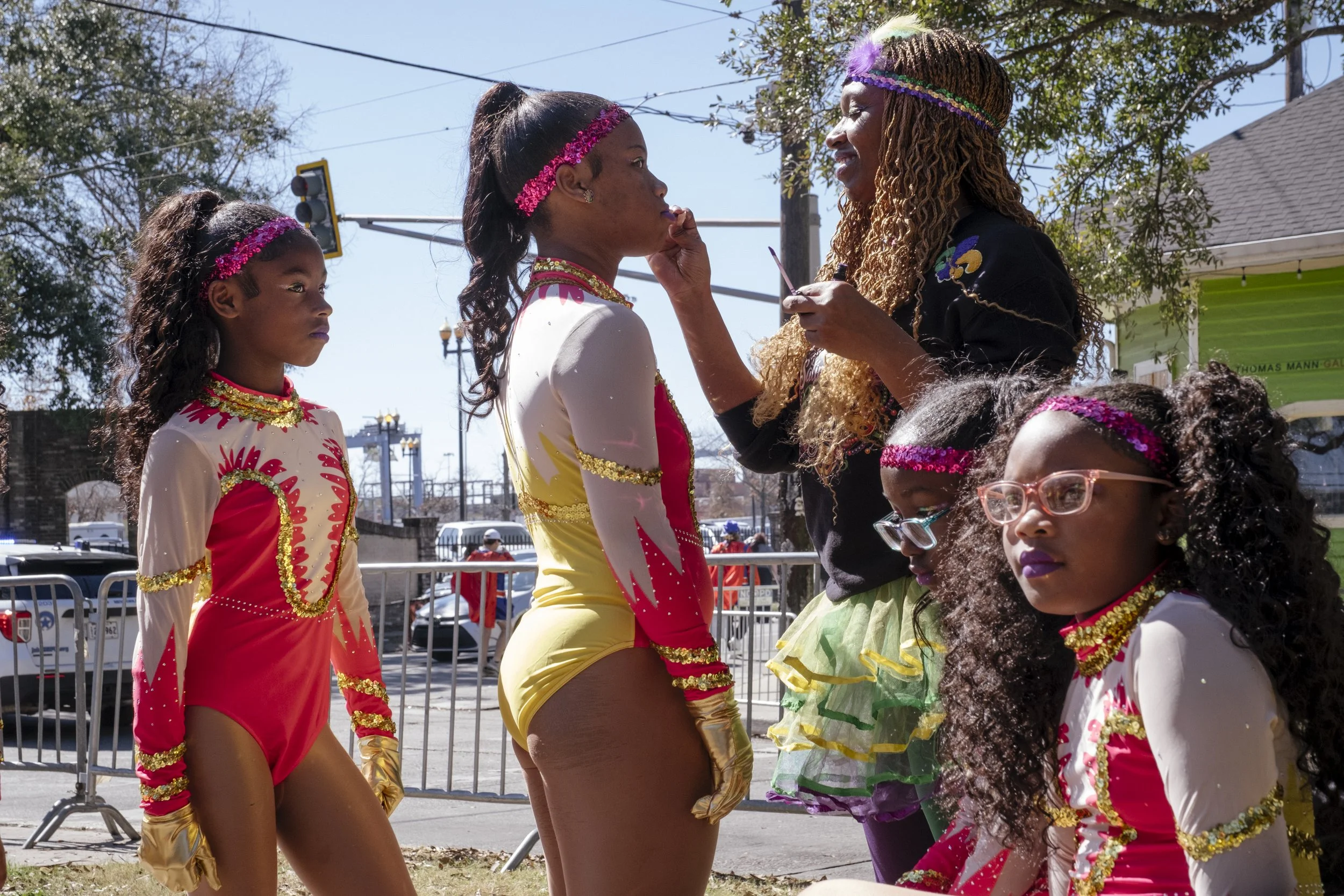 Shantelle Robinson, a board member and the director of coaches for N.O.E Satin Dolls, touches up the girls makeup before they perform in the Mardi Gras Mystic krewe of Femme Fatale parade in New Orleans, Louisiana on February 8, 2026.