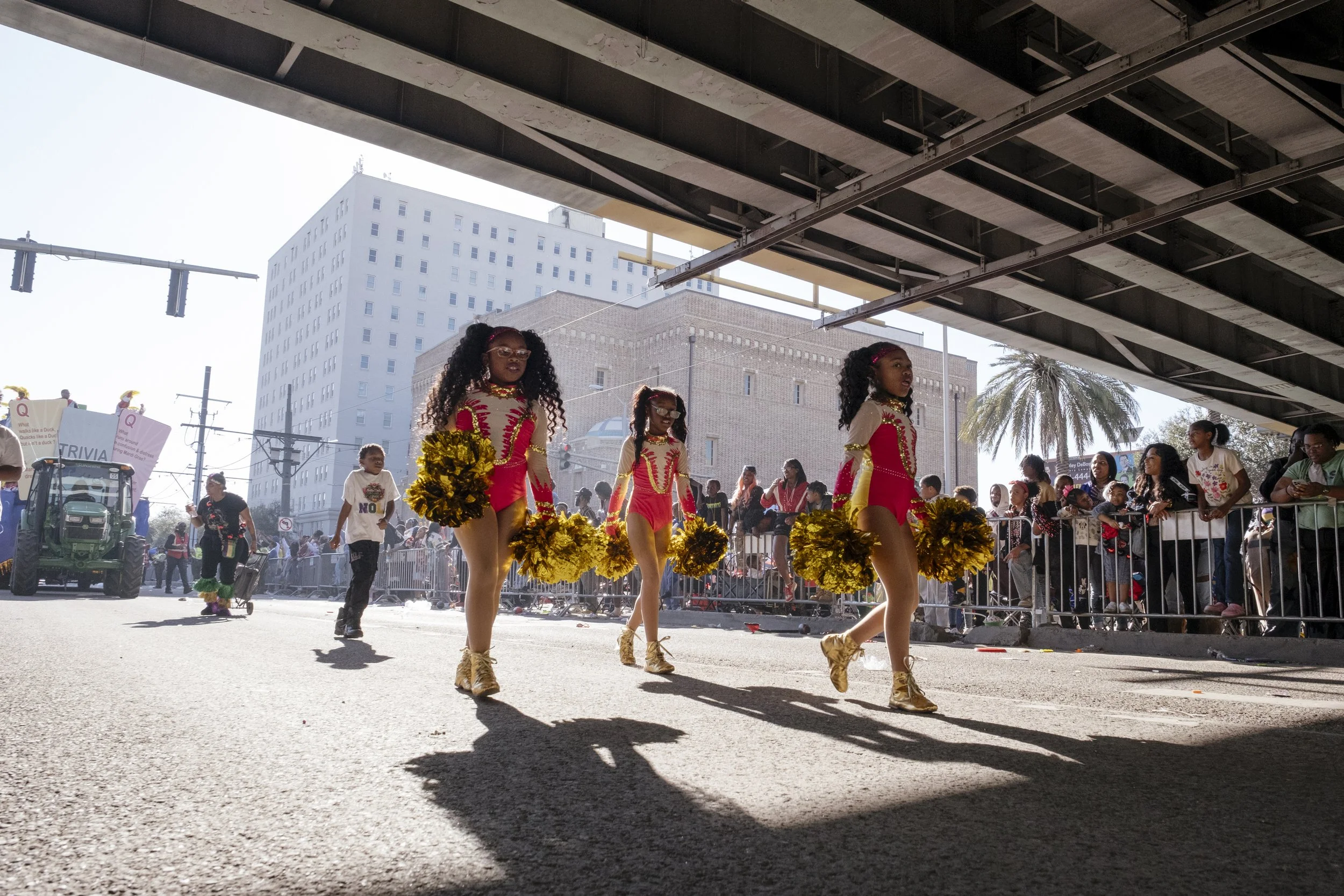 Members of the N.O.E Satin Dolls walk underneath the famous Magnolia Bridge downtown in the Mardi Gras Mystic Krewe of Femme Fatale parade in New Orleans, Louisiana on February 8, 2026.  