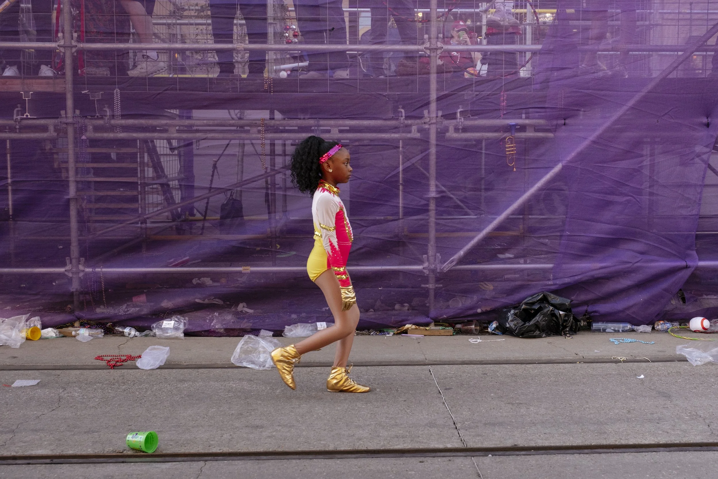 Tiny, 9, walks through the streets in the Mardi Gras Mystic Krewe of Femme Fatale parade on February 8, 2026.  