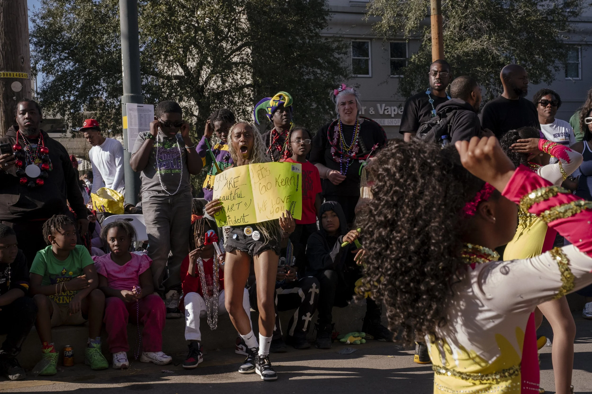 Brideisha Harness, a previous board member of N.O.E Satin Dolls Dance, cheers for the girls on the team near the Magnolia Bridge in New Orleans, Louisiana on February 8, 2026.