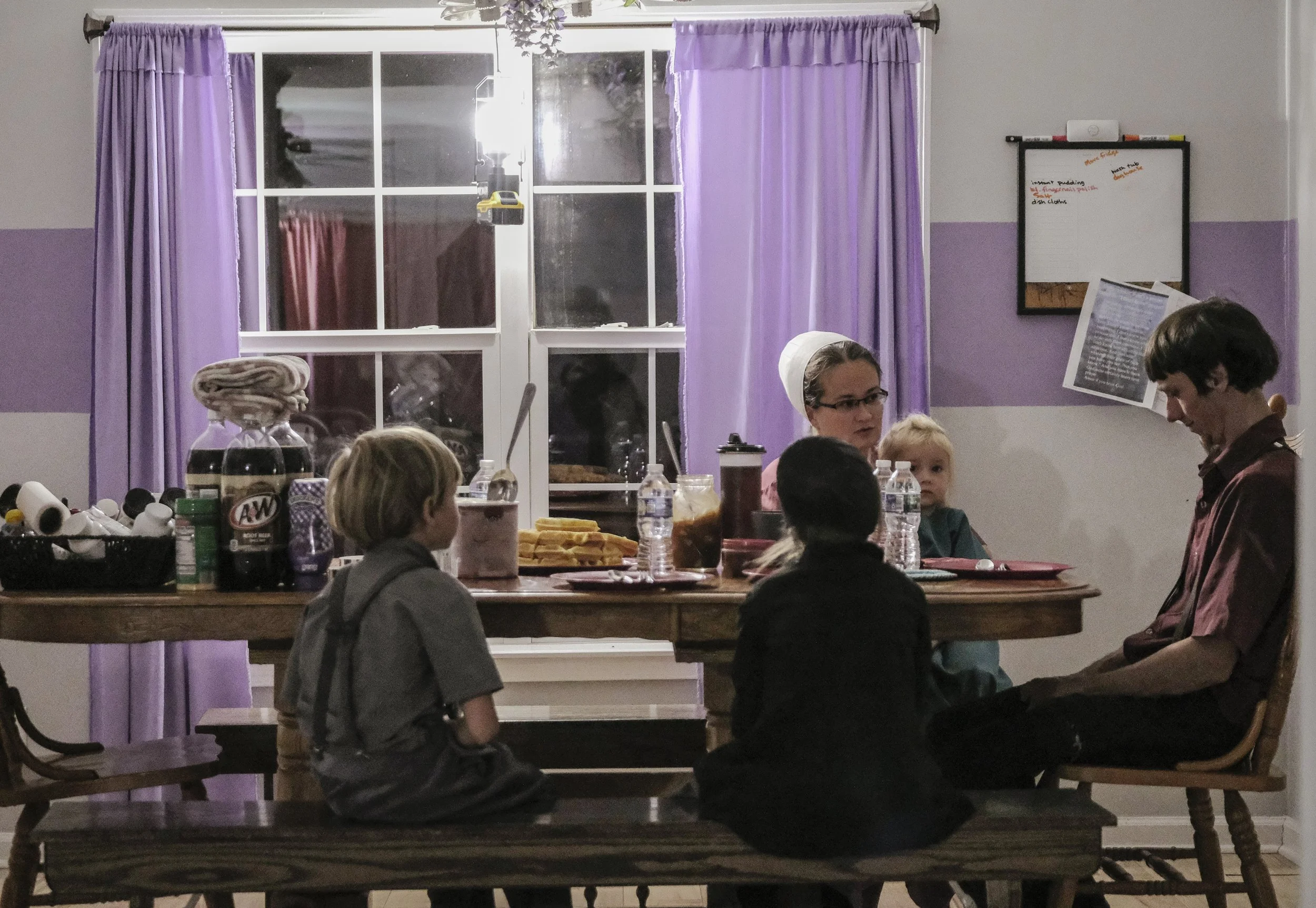 The Yoder family begins their breakfast at 6:00 in the morning so they have time for devotions and chores, on Oct 23 in Mays Lick, KY.  Their breakfast consists of waffles topped with ice cream, pie filling, and sausage's. 