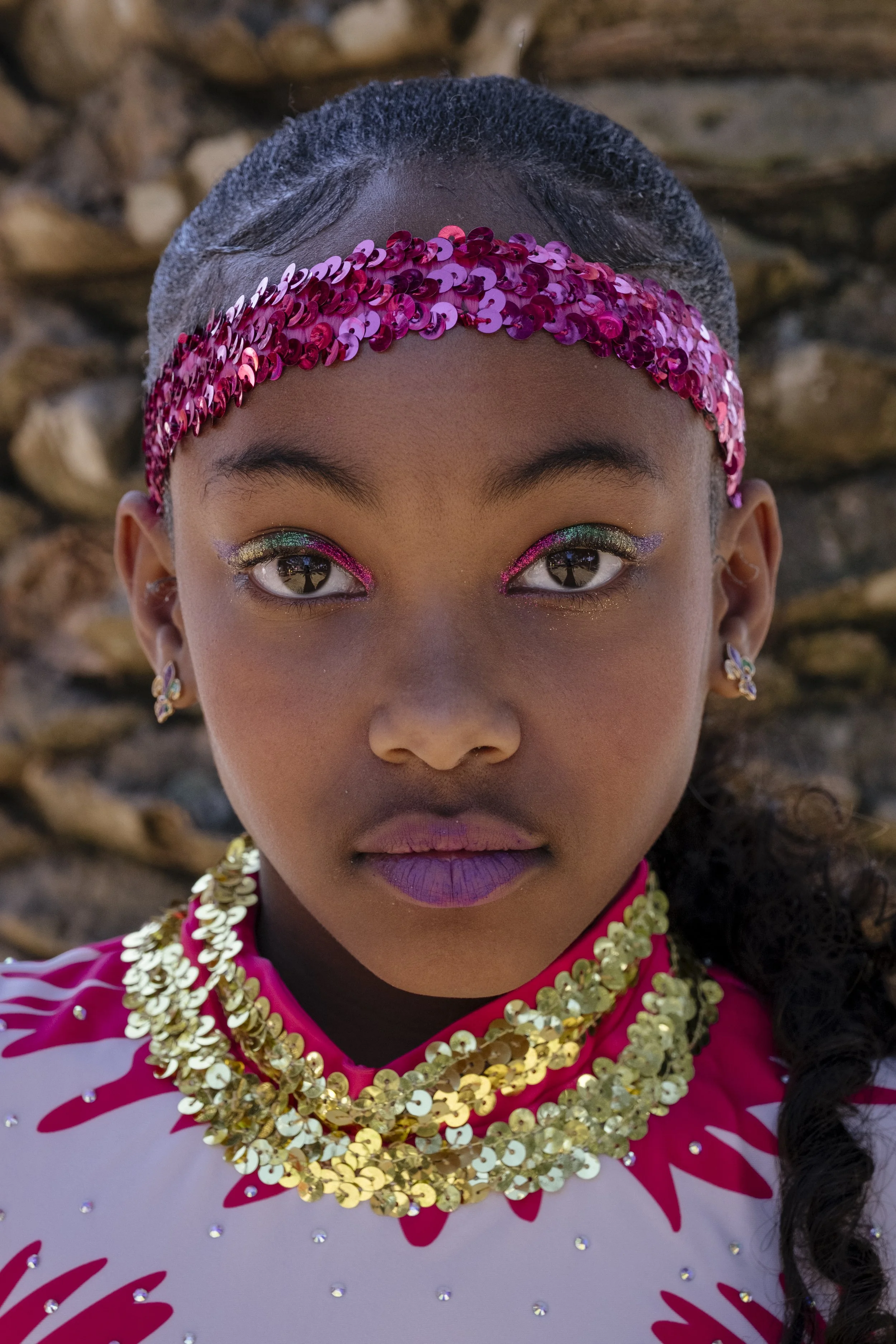 Tiny, 9, a member of N.O.E Satin Dolls stands for a portrait before she dances in the Mardi Gras Mystic krewe of Femme Fatale parade in New Orleans, Louisiana on February 8, 2026.