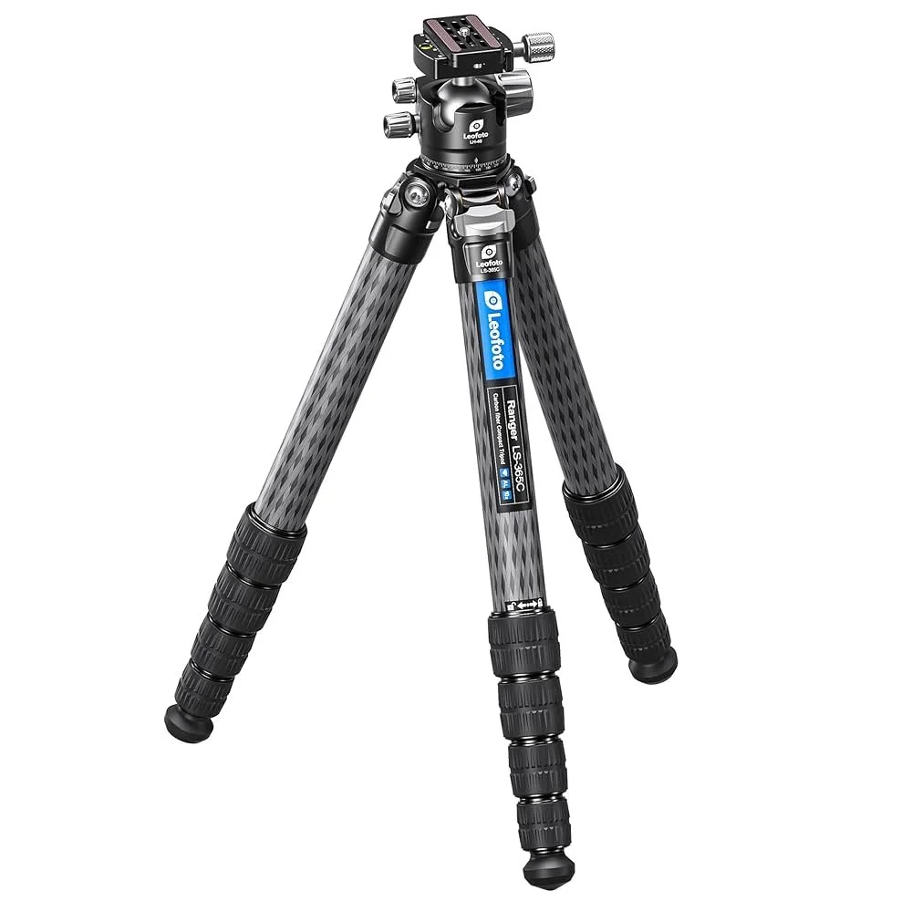 A black and silver Leofoto tripod with carbon fiber legs and adjustable height, featuring a mounting head on top.