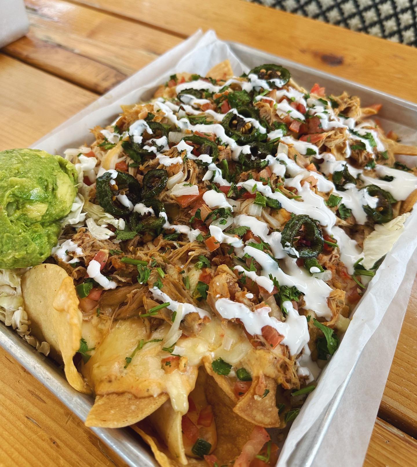 House-made chips, queso blanco, melted chihuahua cheese, pico, grilled jalape&ntilde;os, guacamole &amp; your choice of protein&hellip; $10 all day today! Grab a friend, we&rsquo;ll see y&rsquo;all on the patio 🍻