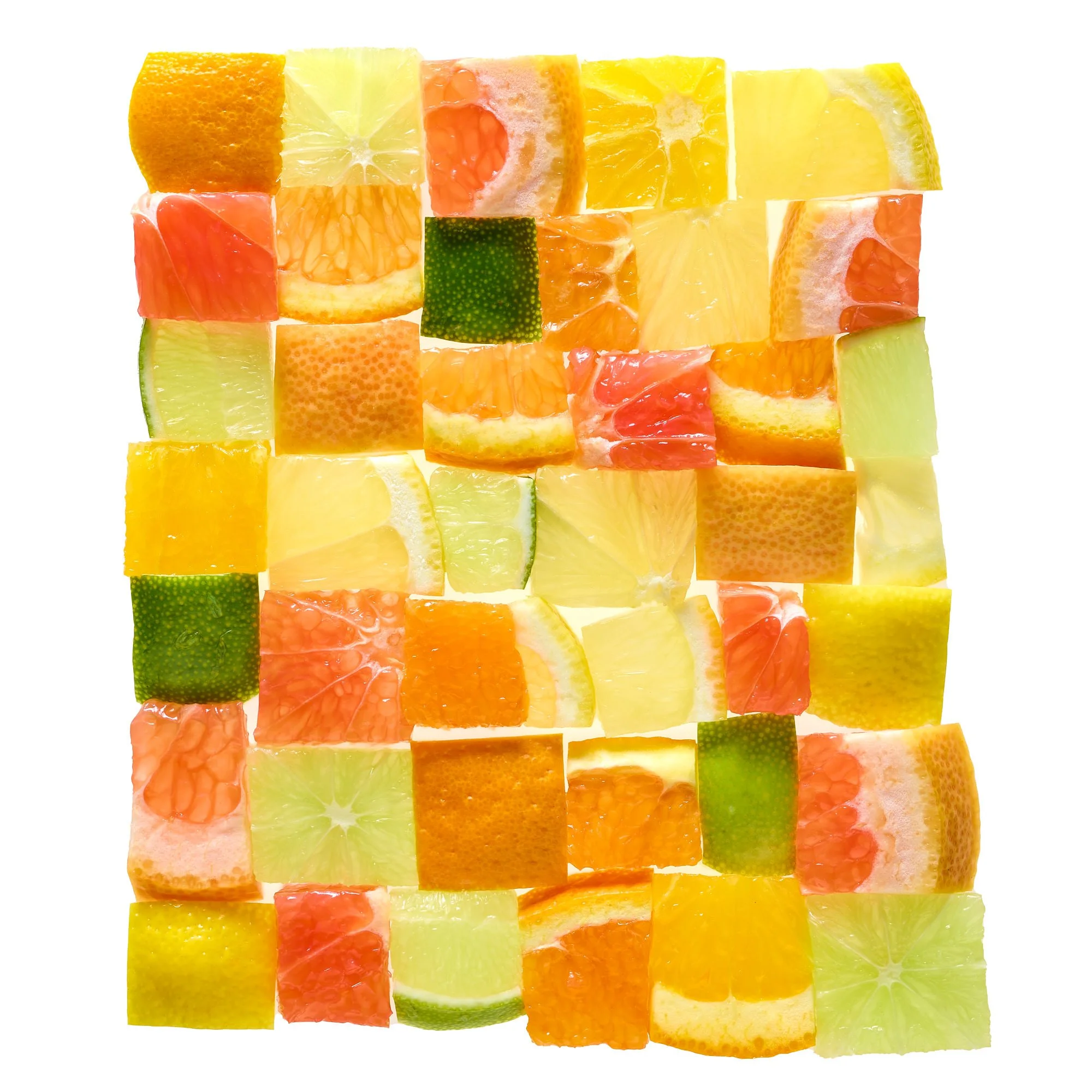 Assorted cubed citrus fruits including oranges, lemons, grapefruits, limes, and mandarins arranged in a grid on a white background.