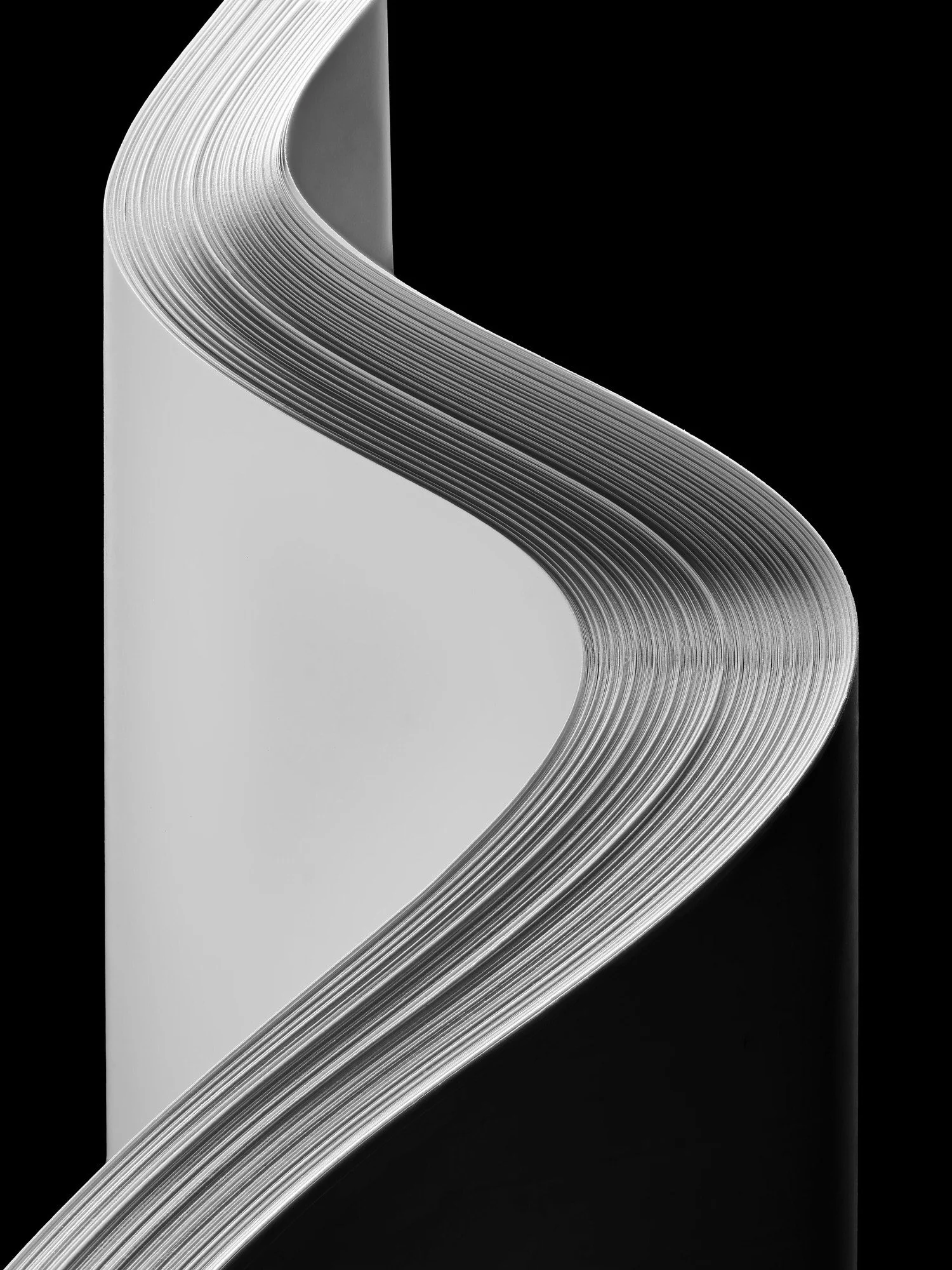 The stark beauty of an s-curve in a stack of white paper on a black background can't be overstated. Looking at everyday objects in a new light is what drives me.