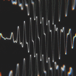 Abstract image of sound waves or audio signal visualization with lines and peaks on a dark background.