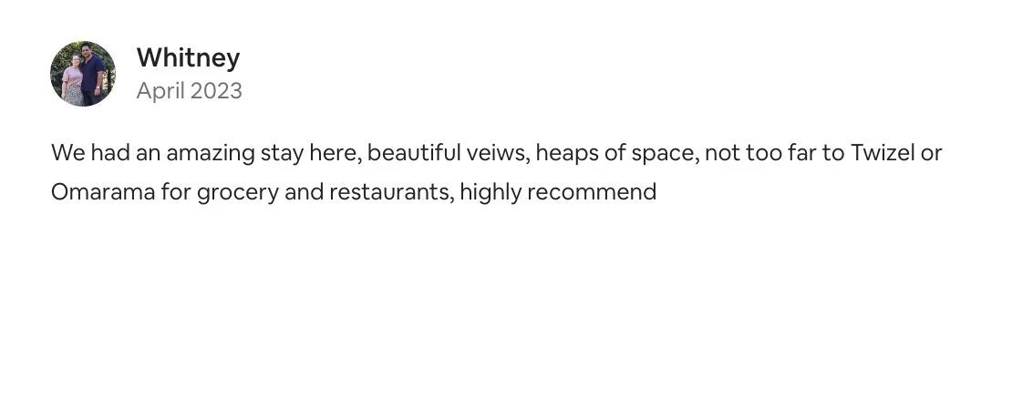 Screenshot of a review from Whitney in April 2023 praising a stay with scenic views, nearby grocery stores, and recommended restaurants.