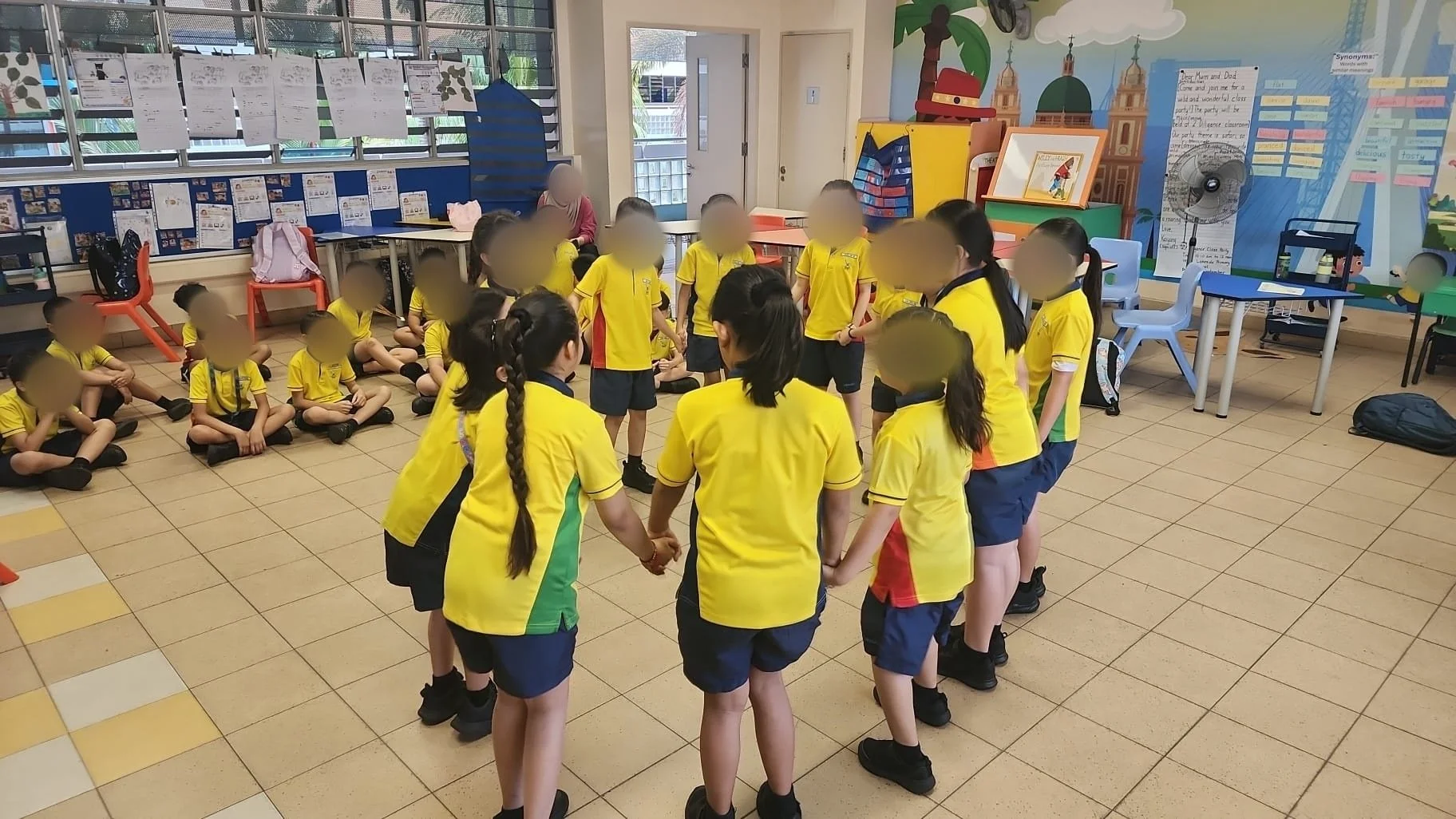 Lower primary pupils playing Jump In Jump Out in a circle