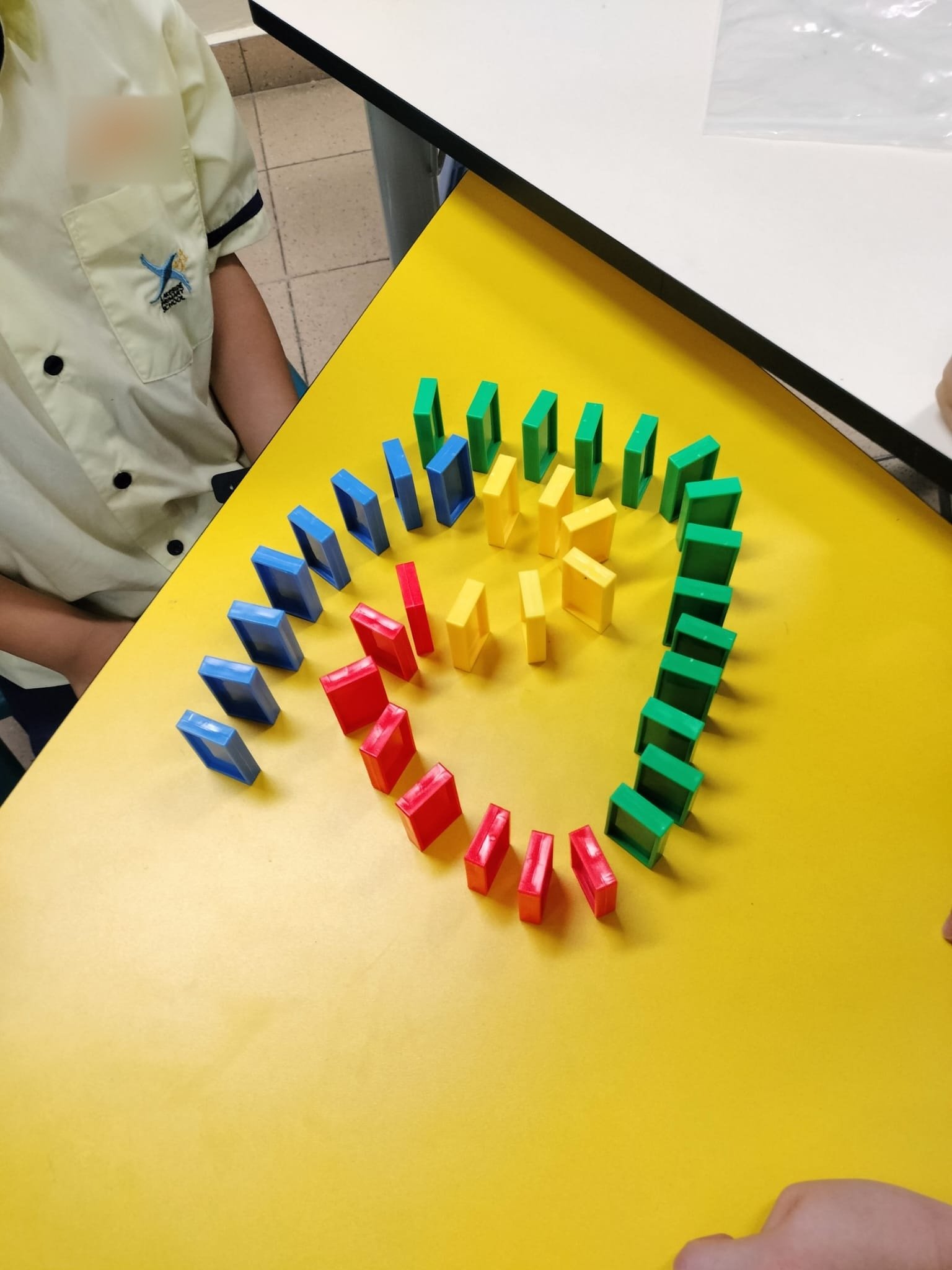 A heart of dominoes built by Primary 1 pupils in the Domino Challenge