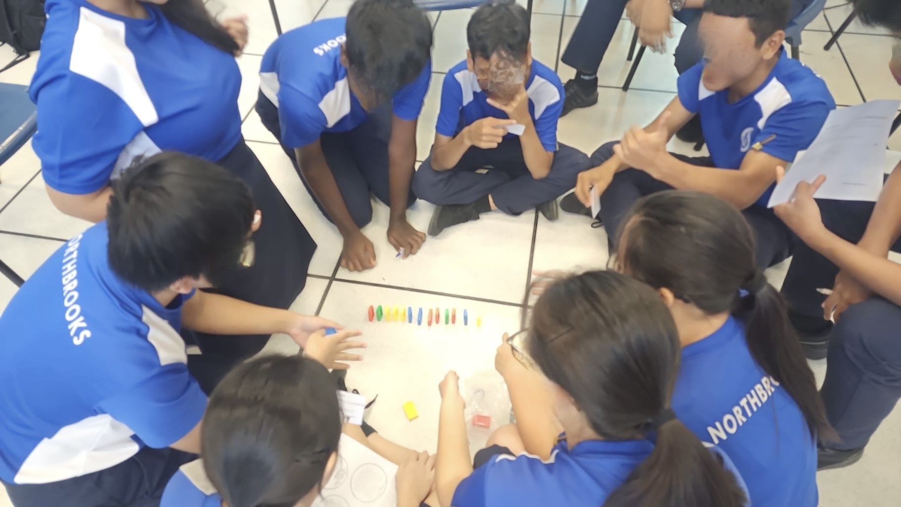 Students building dominos as a communication activity