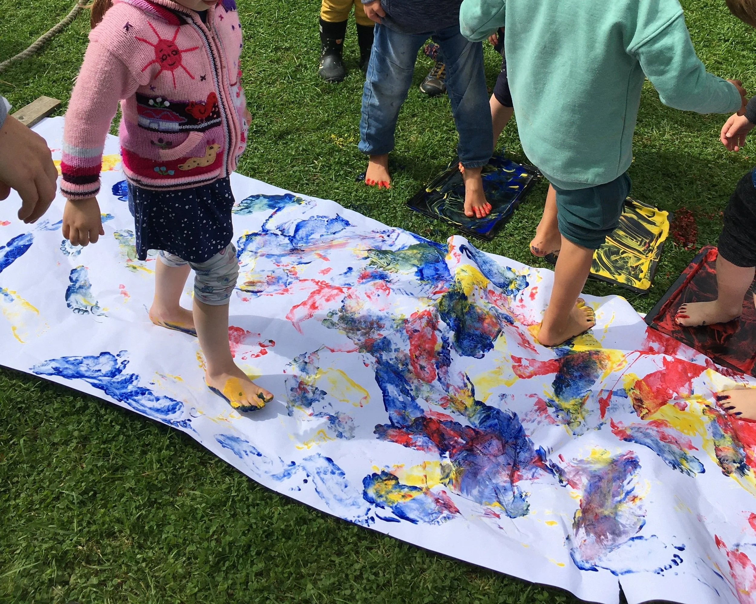 Children outdoors foot print painting