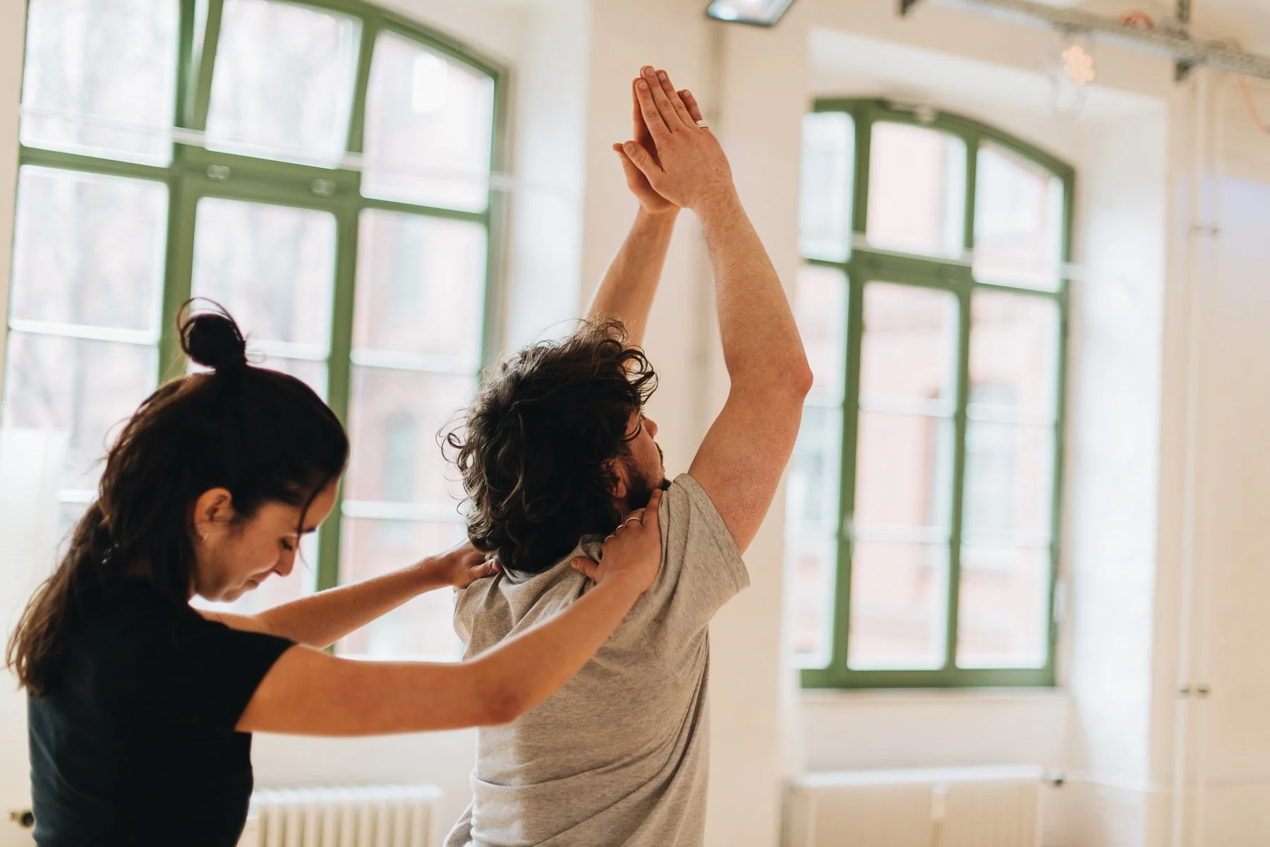 yoga students assisting each other in asana practice