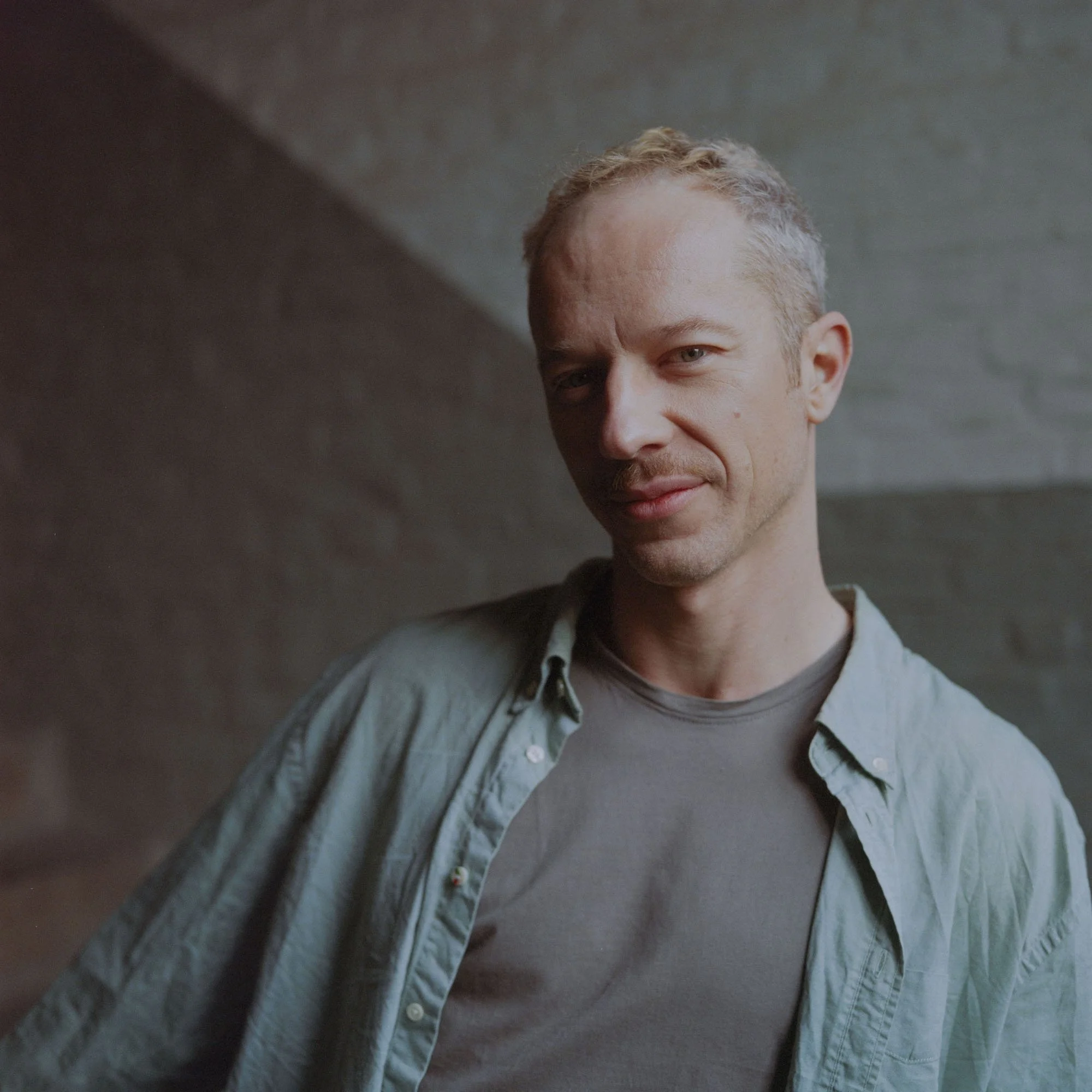 yoga teacher with yoga student in the background