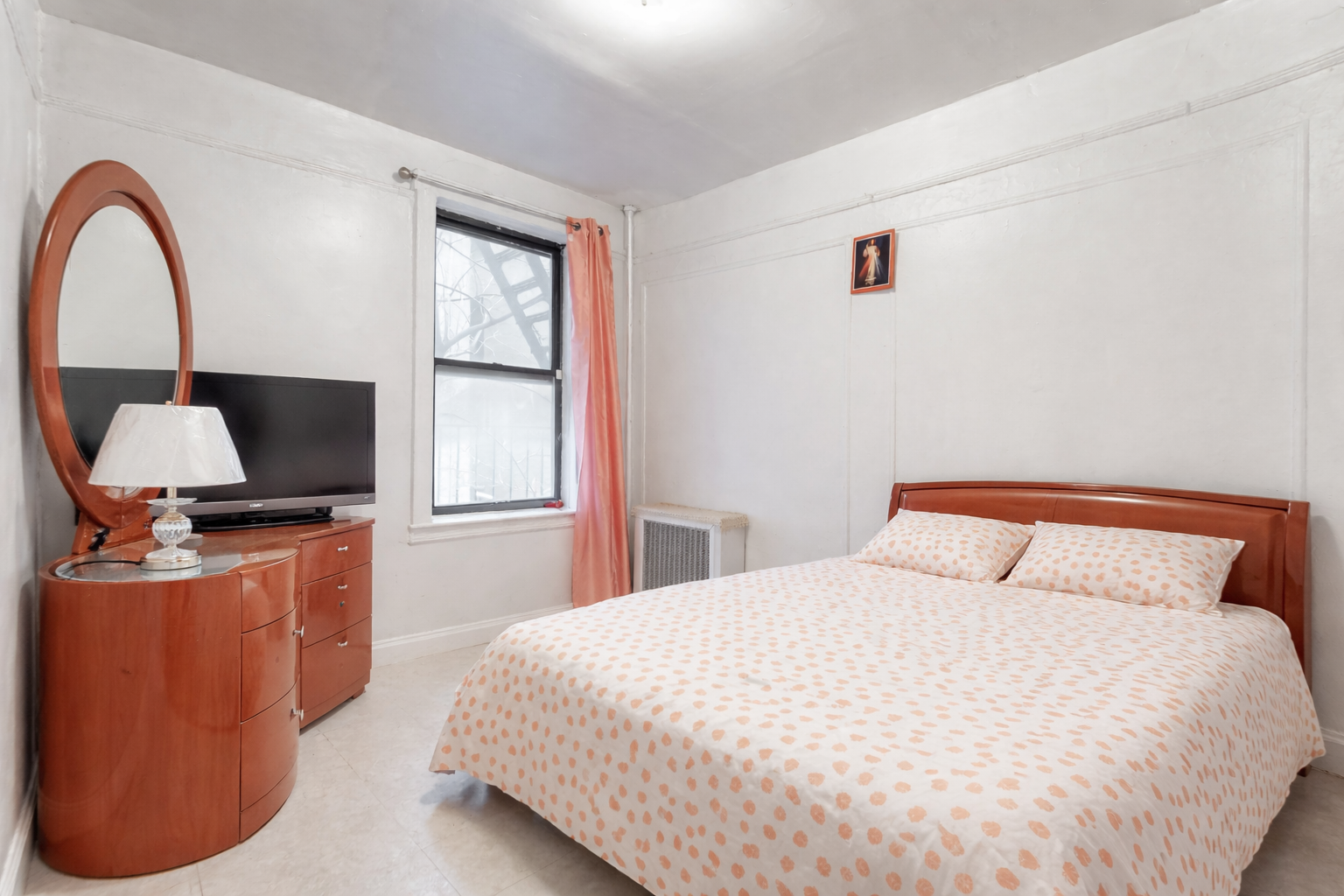 Cozy bedroom with cherry wood accents.png