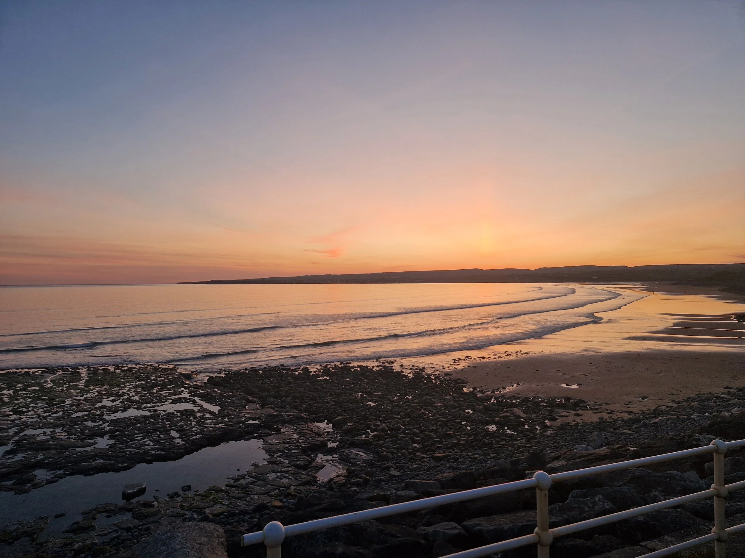 Coastal scenic view of a sunset at Lahinch Beach in County Clare