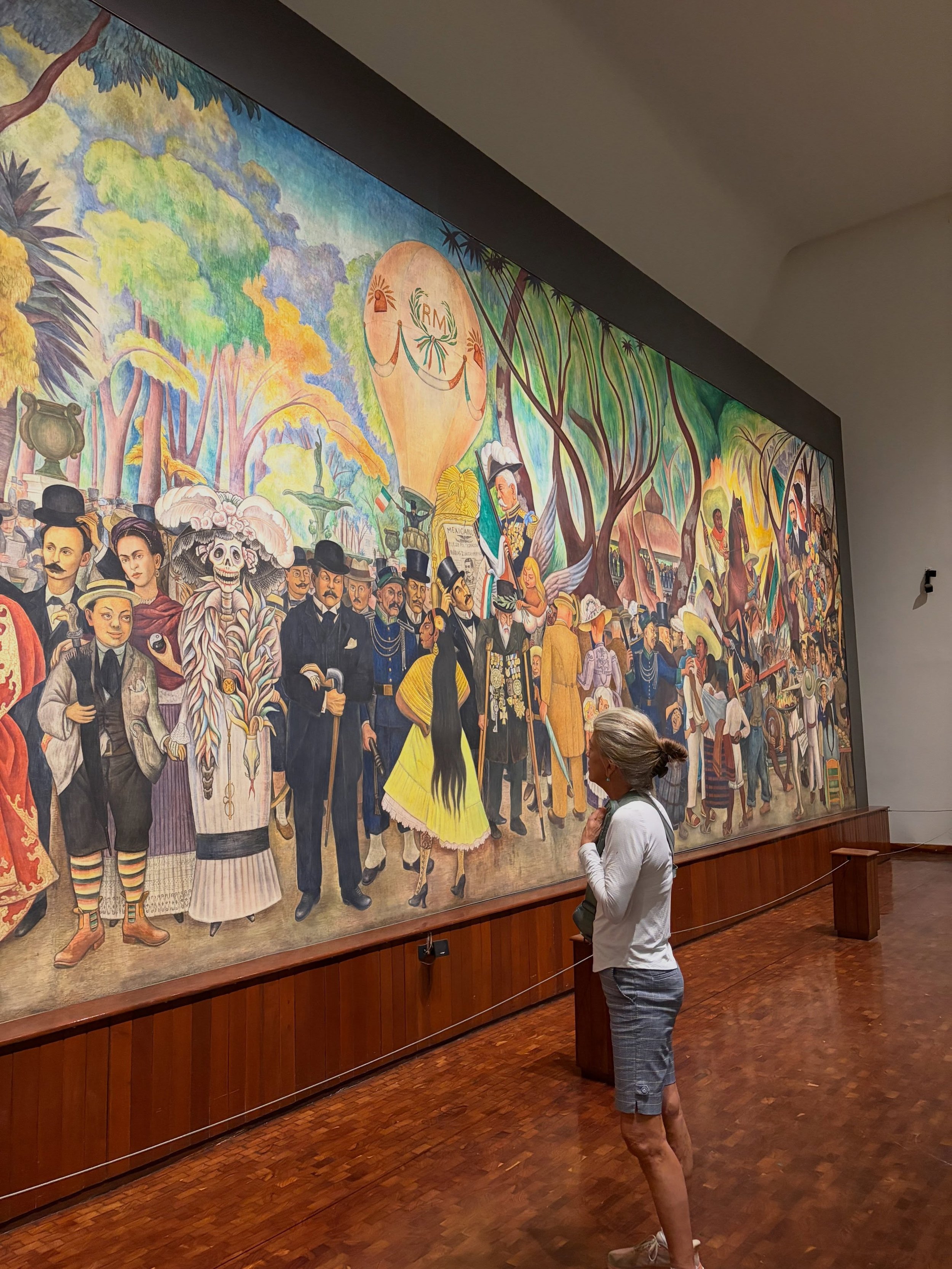 &lsquo;Dream of a Sunday Afternoon in the Alameda Central&rsquo;

This mural by Diego Rivera took my breath away. The social commentary,  the expressive characters, the color &amp; design of the whole scene is mesmerizing. It luckily survived the ear