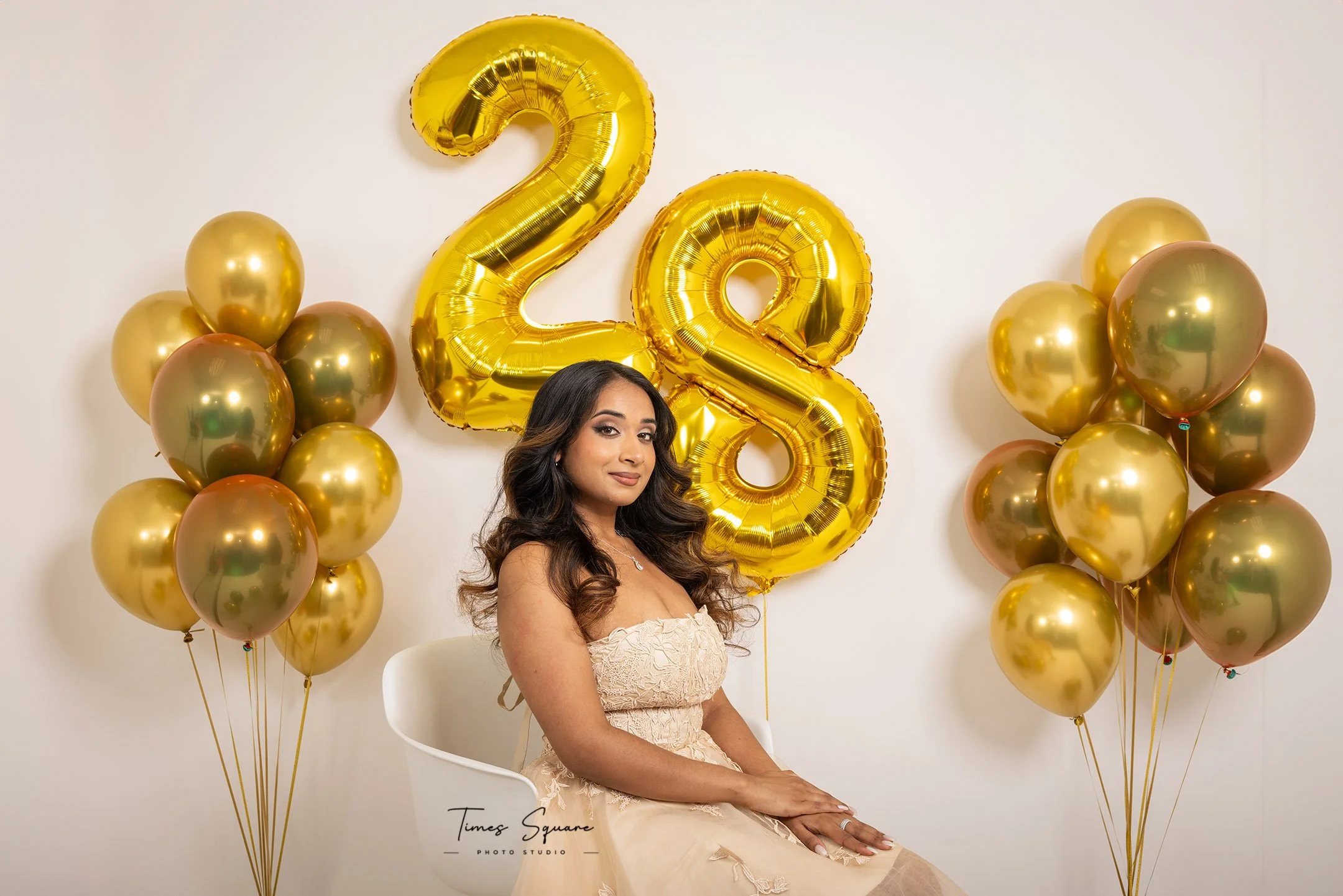 Custom birthday photography session in a New York City studio featuring golden balloons, elegant styling, and fashion-inspired lighting.
