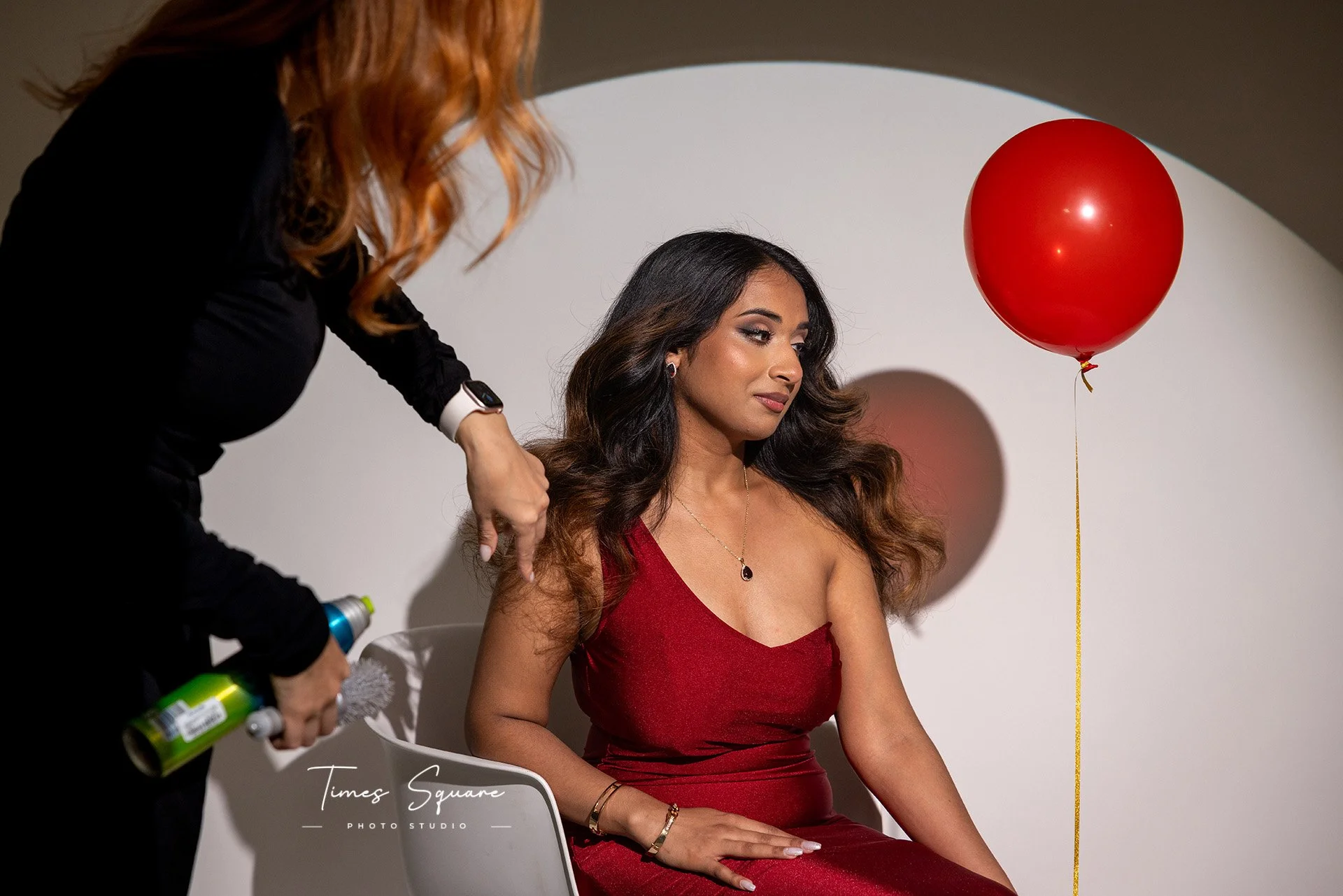 Professional hair styling preparation before a birthday photoshoot in a New York City photography studio.