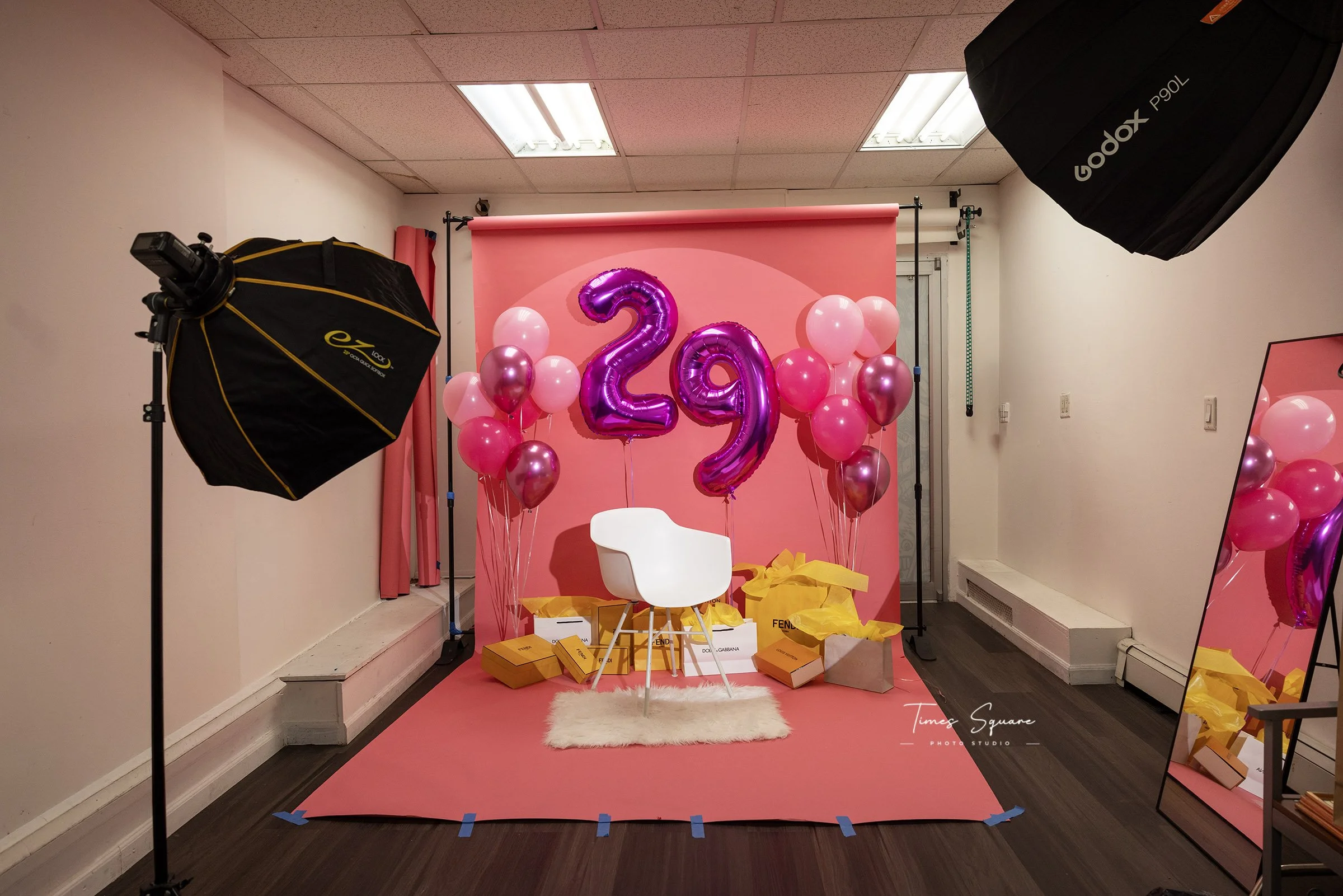 Pink birthday photoshoot setup with number balloons in NYC studio