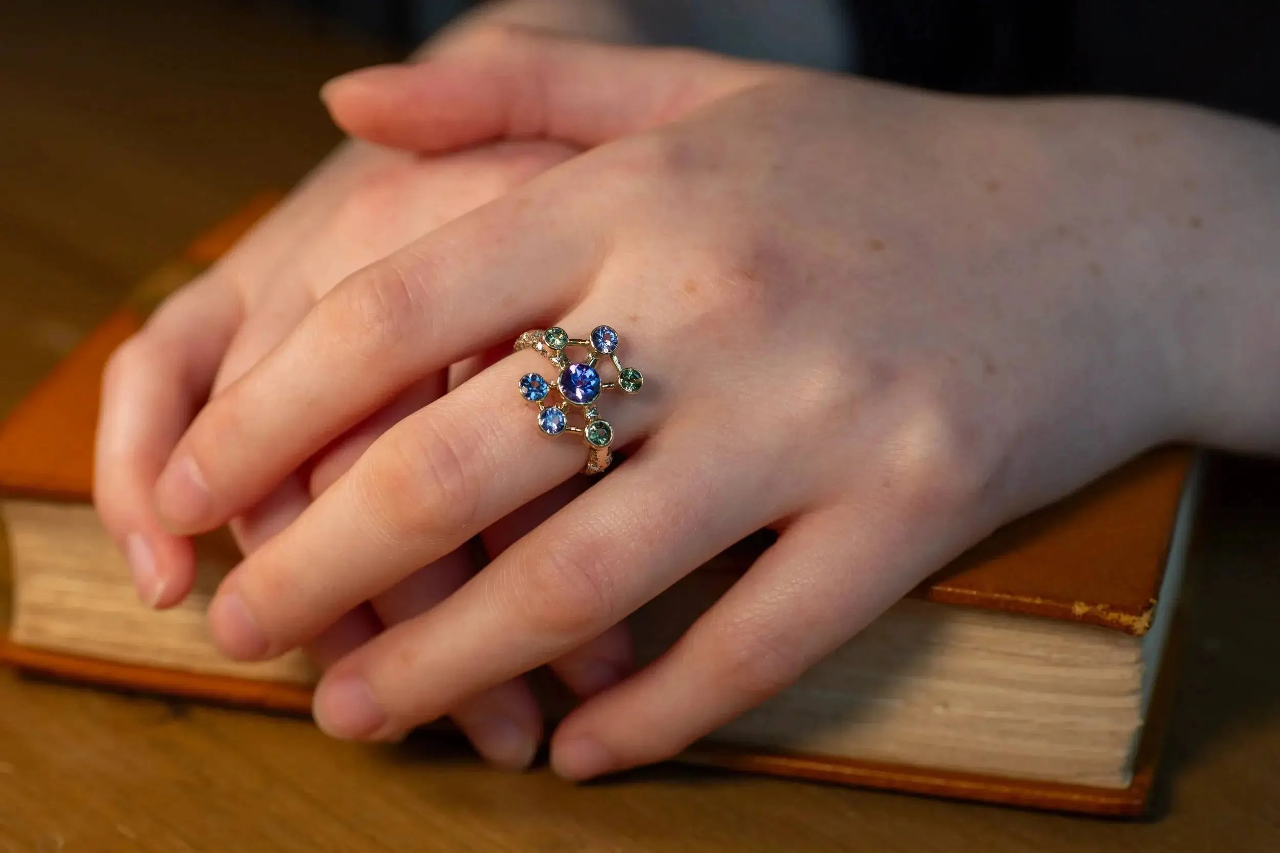 Atomium Ring No. 8 by Iain Sainsbury, 9ct SMO gold sandcast with Cornish Serpentine sand, set with Tanzanite, Sapphires, and Ocean Diamonds.